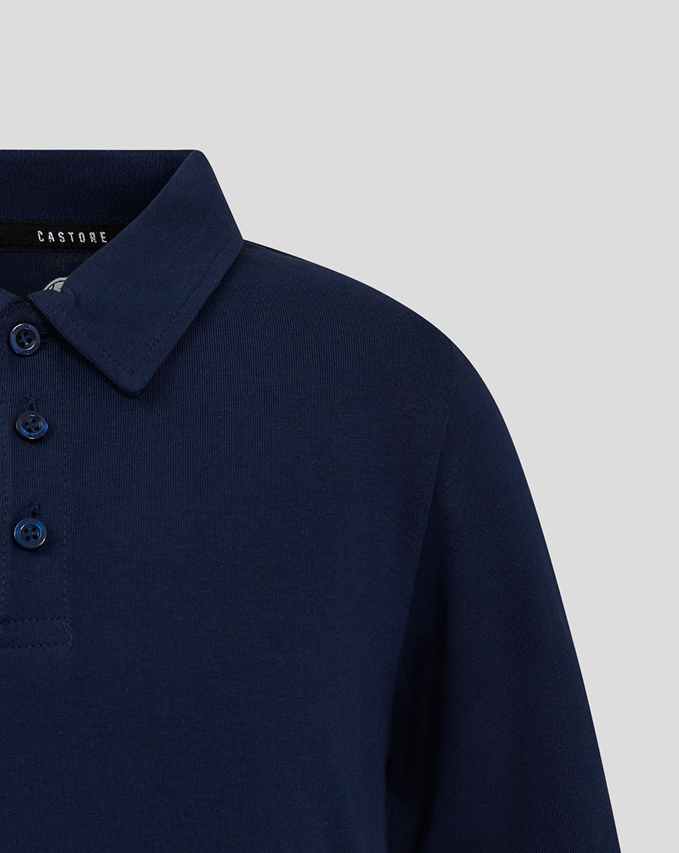 Close-up of navy polo showing the collar and button placket with blue buttons.
