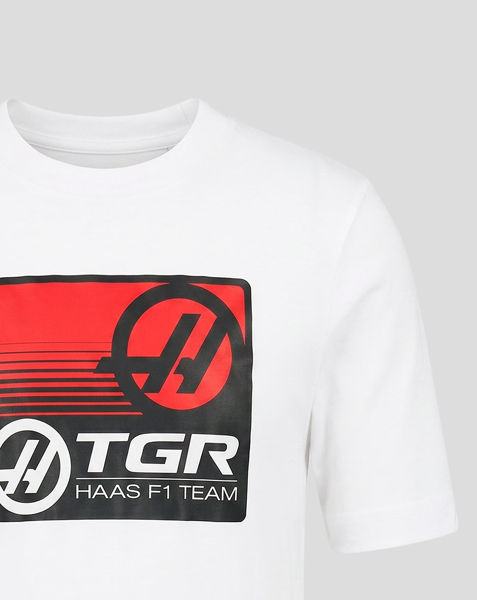 White t-shirt with TGR Haas F1 Team logo on a gray background