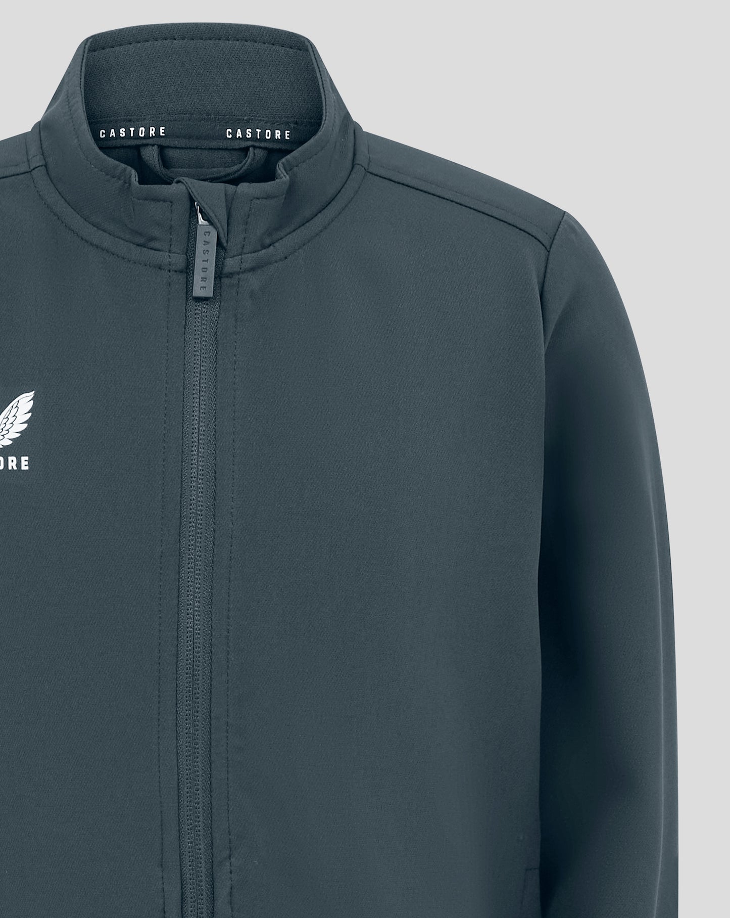 Junior Track Jacket in dark slate close up of collar with full zip and Castore branding