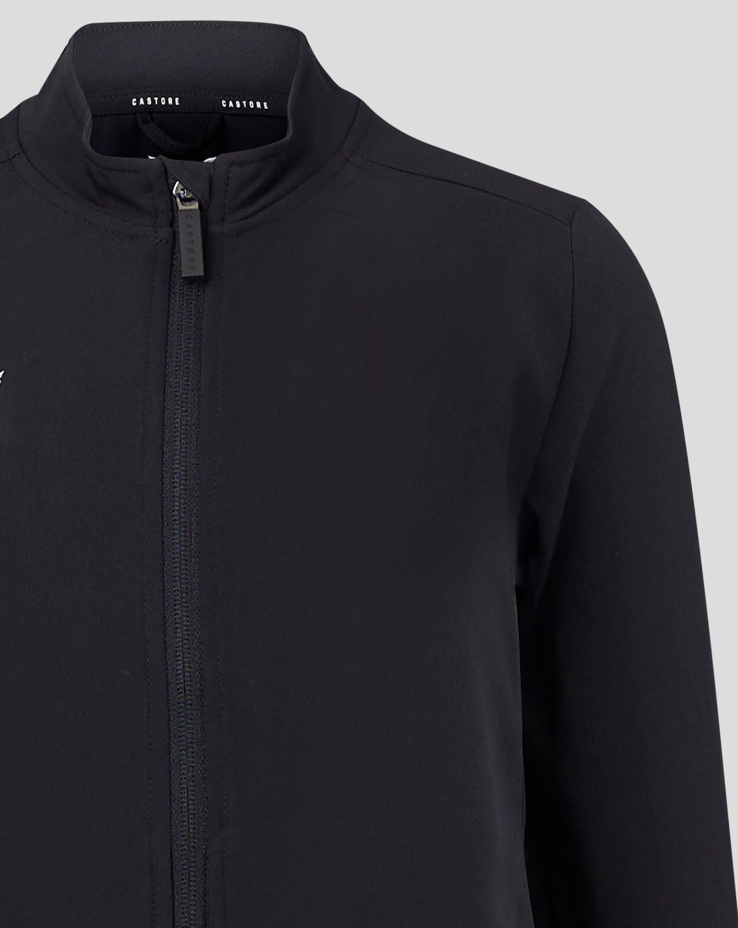 Back view of black Junior Track Jacket neck showing Castore branding along the collar tape.