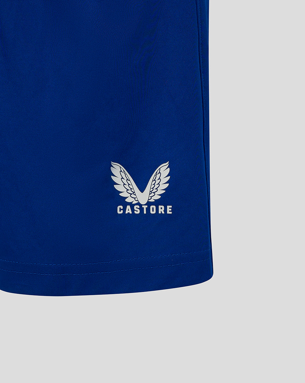 Castore logo on the blue junior match shorts near the hem area
