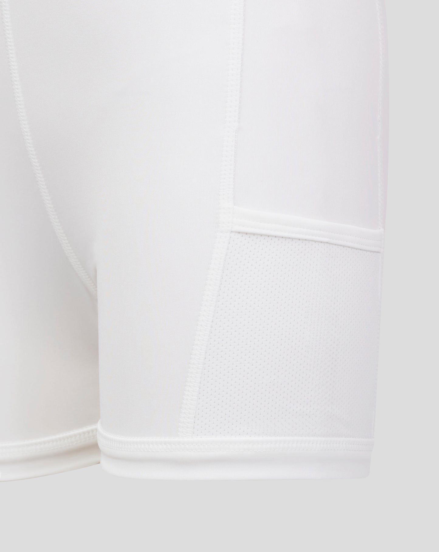 Close up of white Junior Skort fabric showing flat front waistband and inner brief with mesh detail