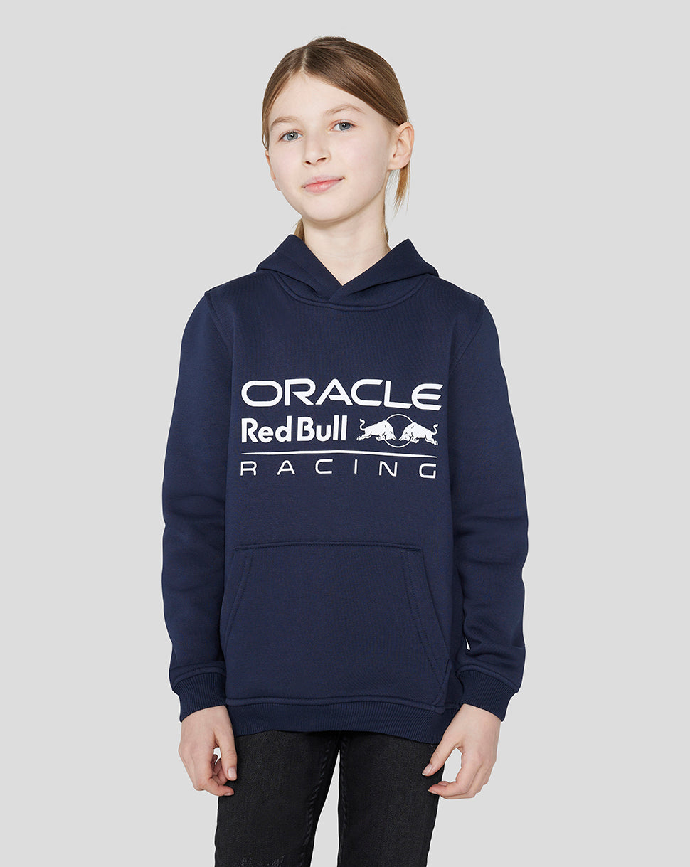 Smiling child wearing a navy Oracle Red Bull Racing hoodie with a large logo across the chest