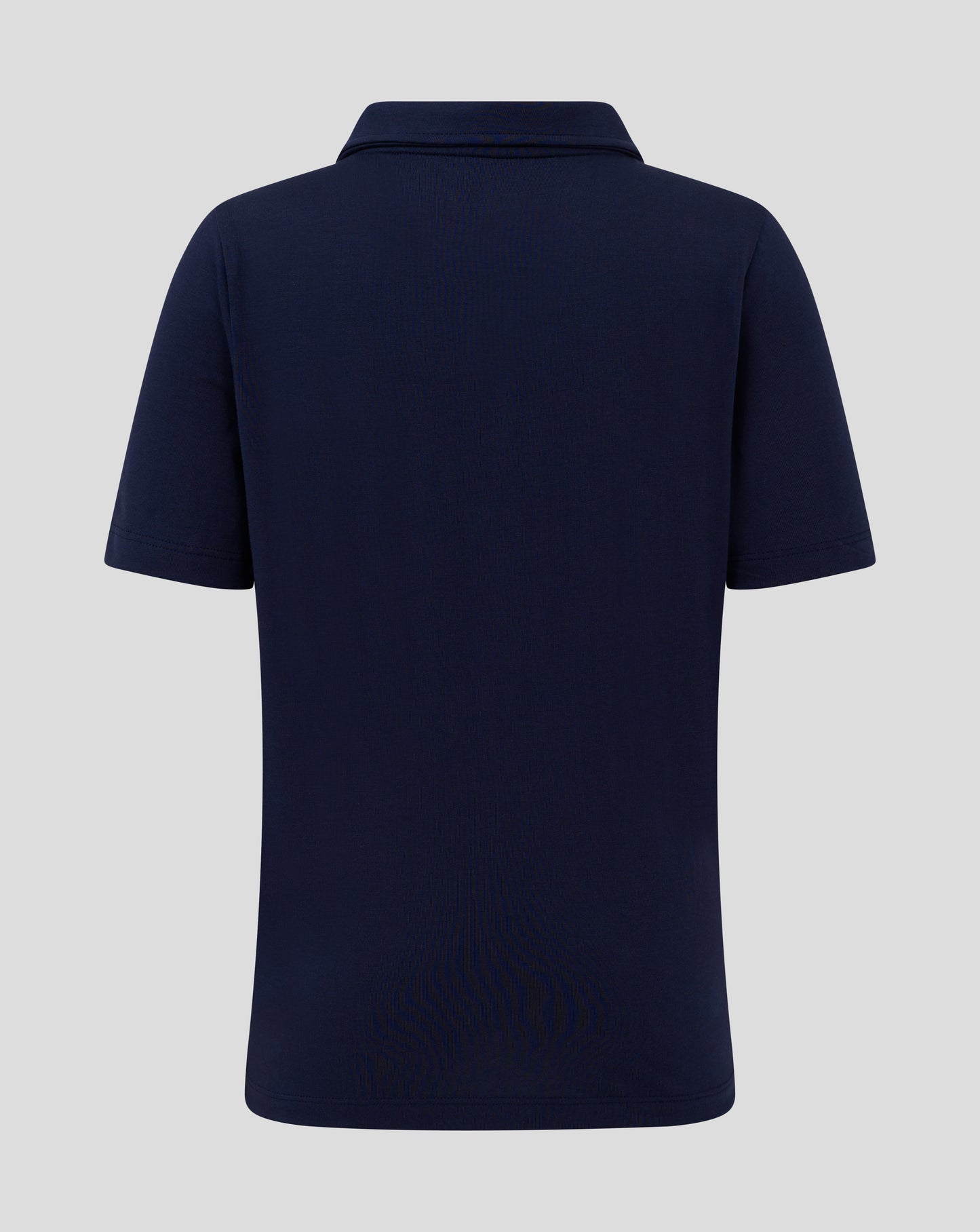 Back view of navy Junior Cotton Leisure Polo showing forward shoulder seam and clean silhouette