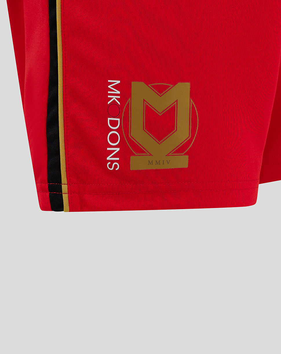 Close up of Mk Dons junior away shorts showing a gold crest and vertical Mk Dons lettering