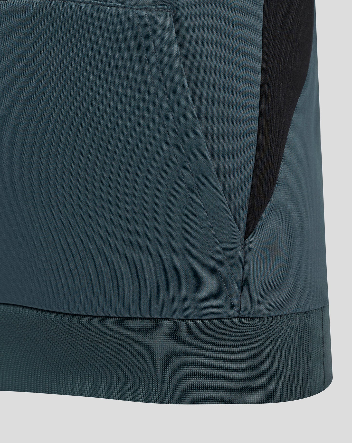 Close-up of teal Bath Rugby Junior training hoodie fabric detailing a front pocket and curved hem