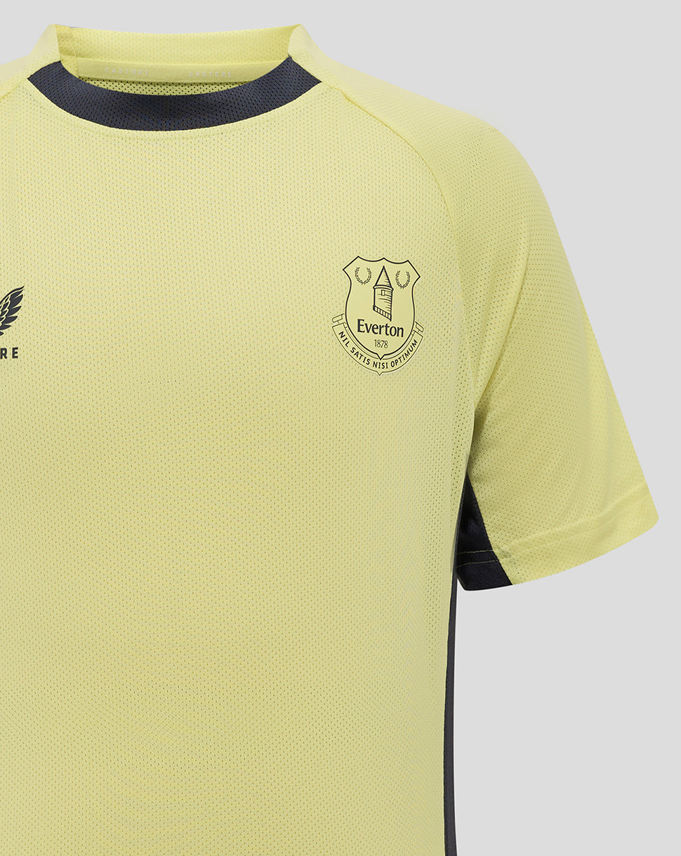 Front view of Everton 24/25 junior training tee in pale yellow with crest on left chest