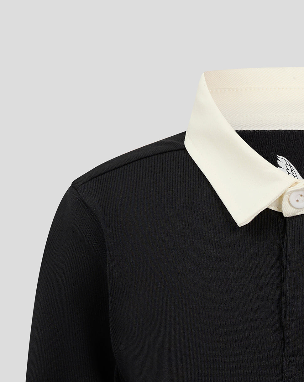 Shoulder and collar detail of black jersey with cream collar and stitching
