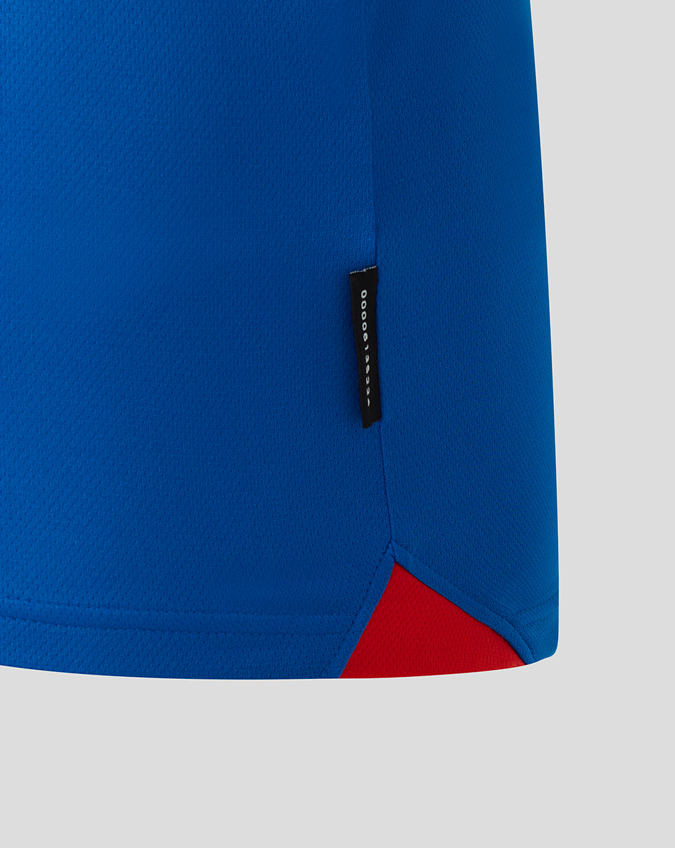 Close-up of blue Rangers home long sleeve jersey fabric with a side seam tag and red hem detail