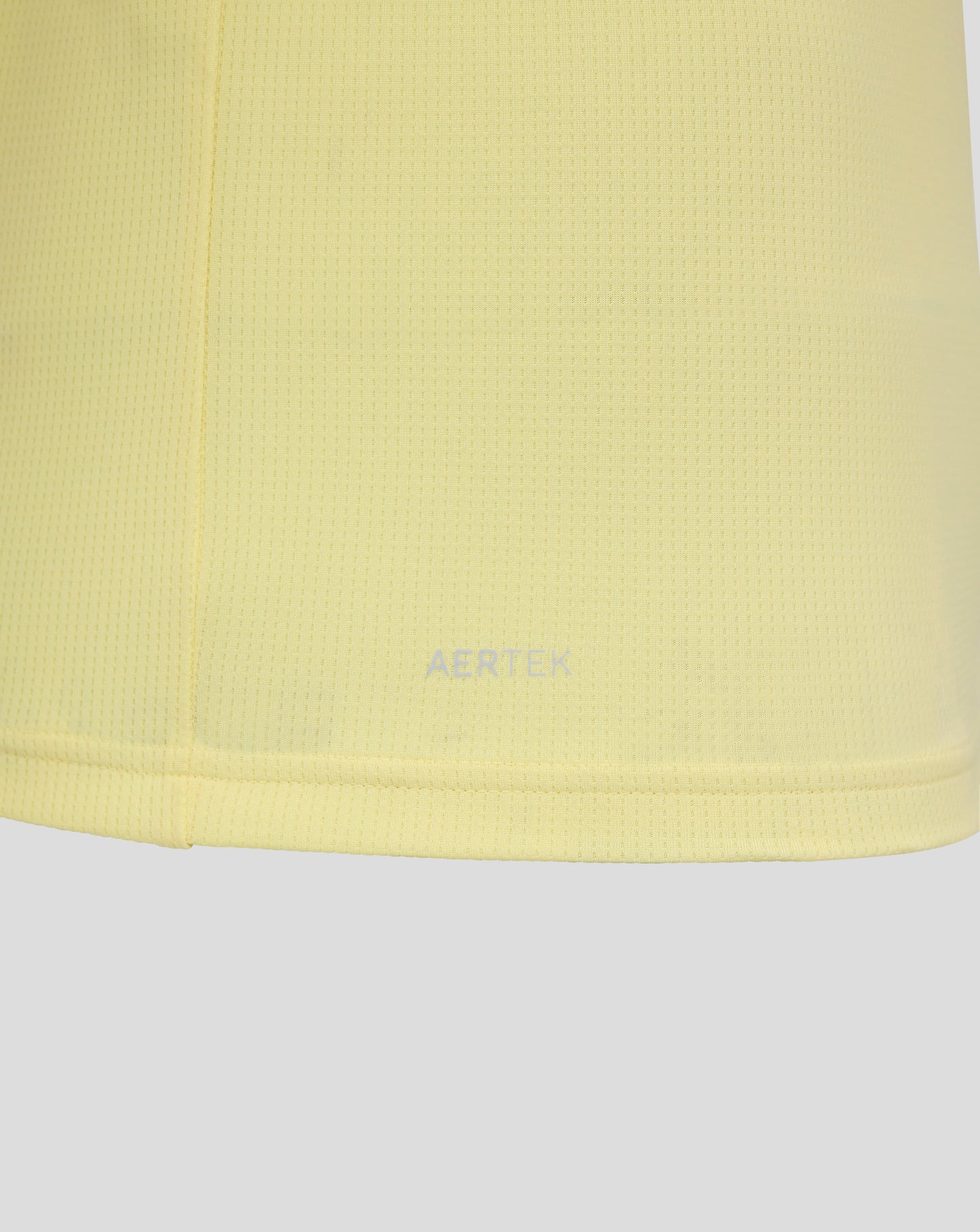 Close up of pale yellow mesh fabric from Everton FC 25/26 junior away short sleeve shirt.