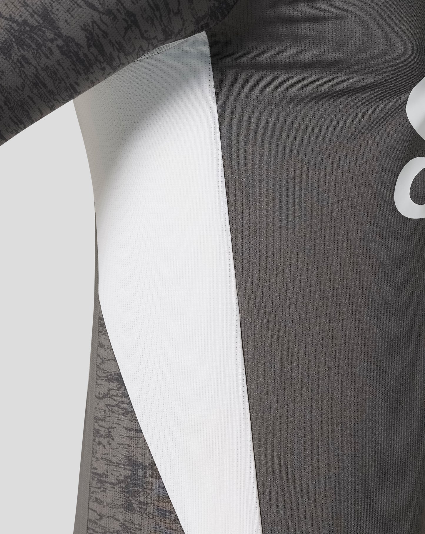 Close up of the shirt fabric showing white center panel and dark gray panels with subtle vertical texture