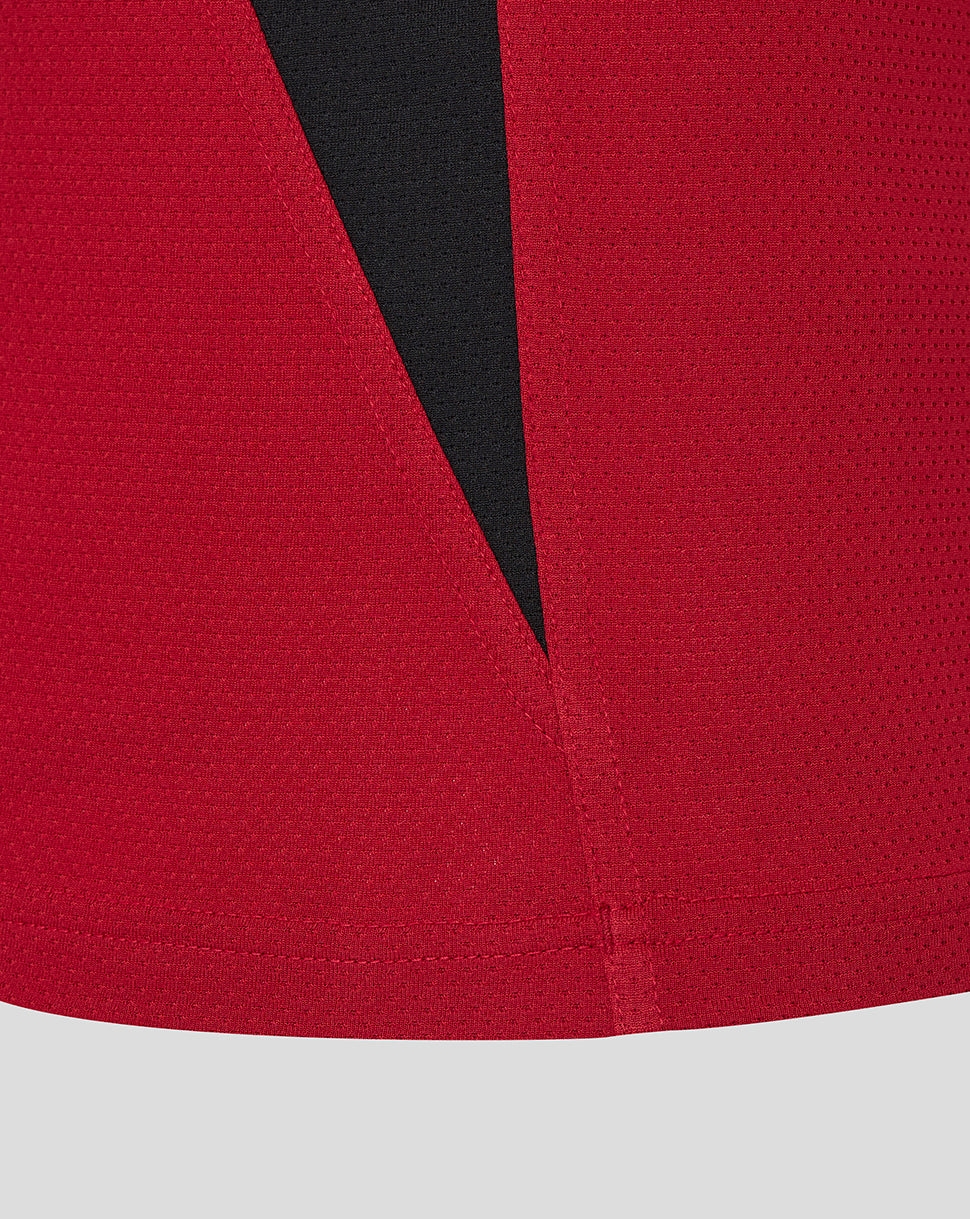 Close up of vibrant red Saracens training tee fabric with a black angular front panel