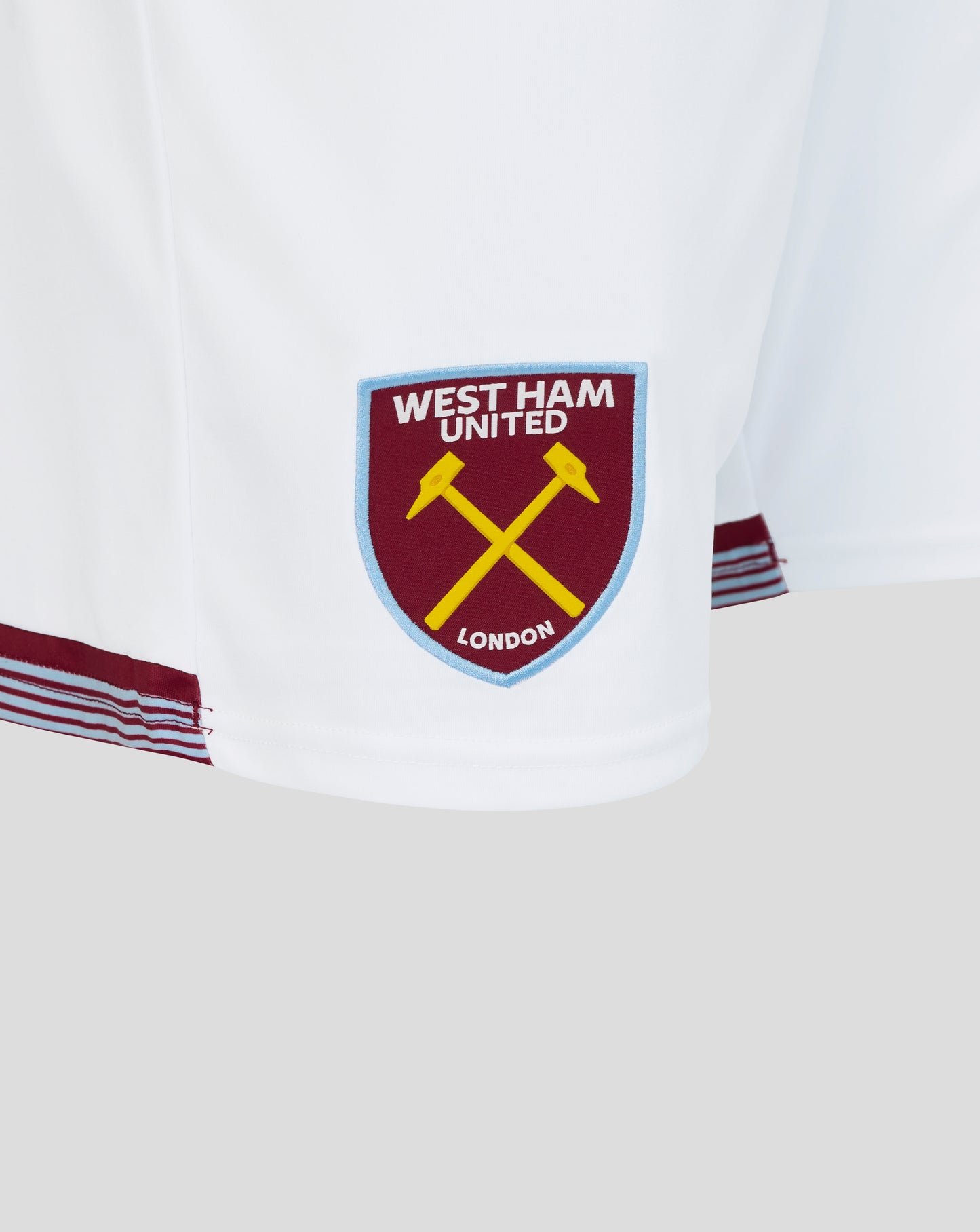White West Ham home shorts featuring a blue bordered crest patch on the leg
