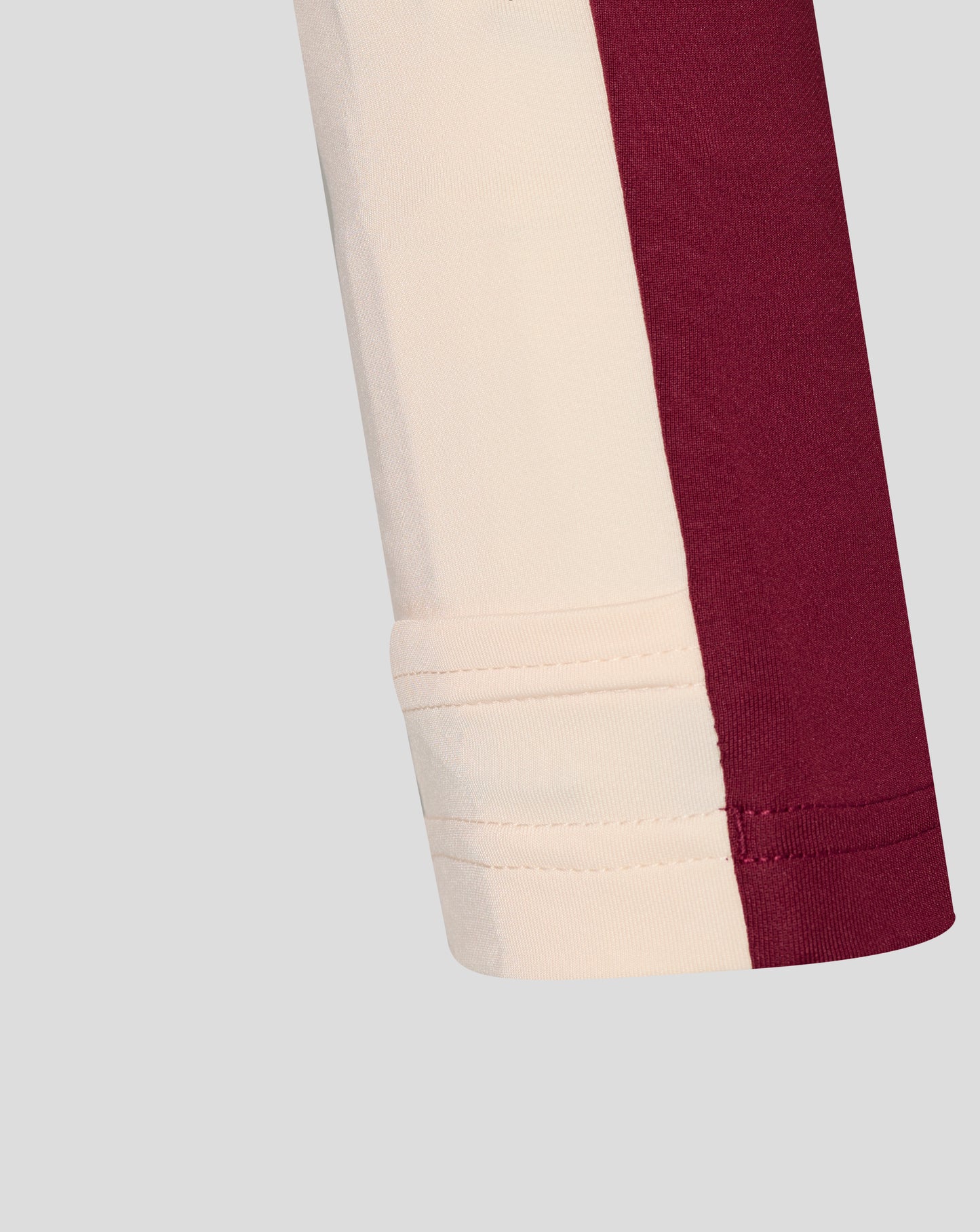 Beige and maroon color block sleeve with cuff stitching on the West Ham training midlayer top