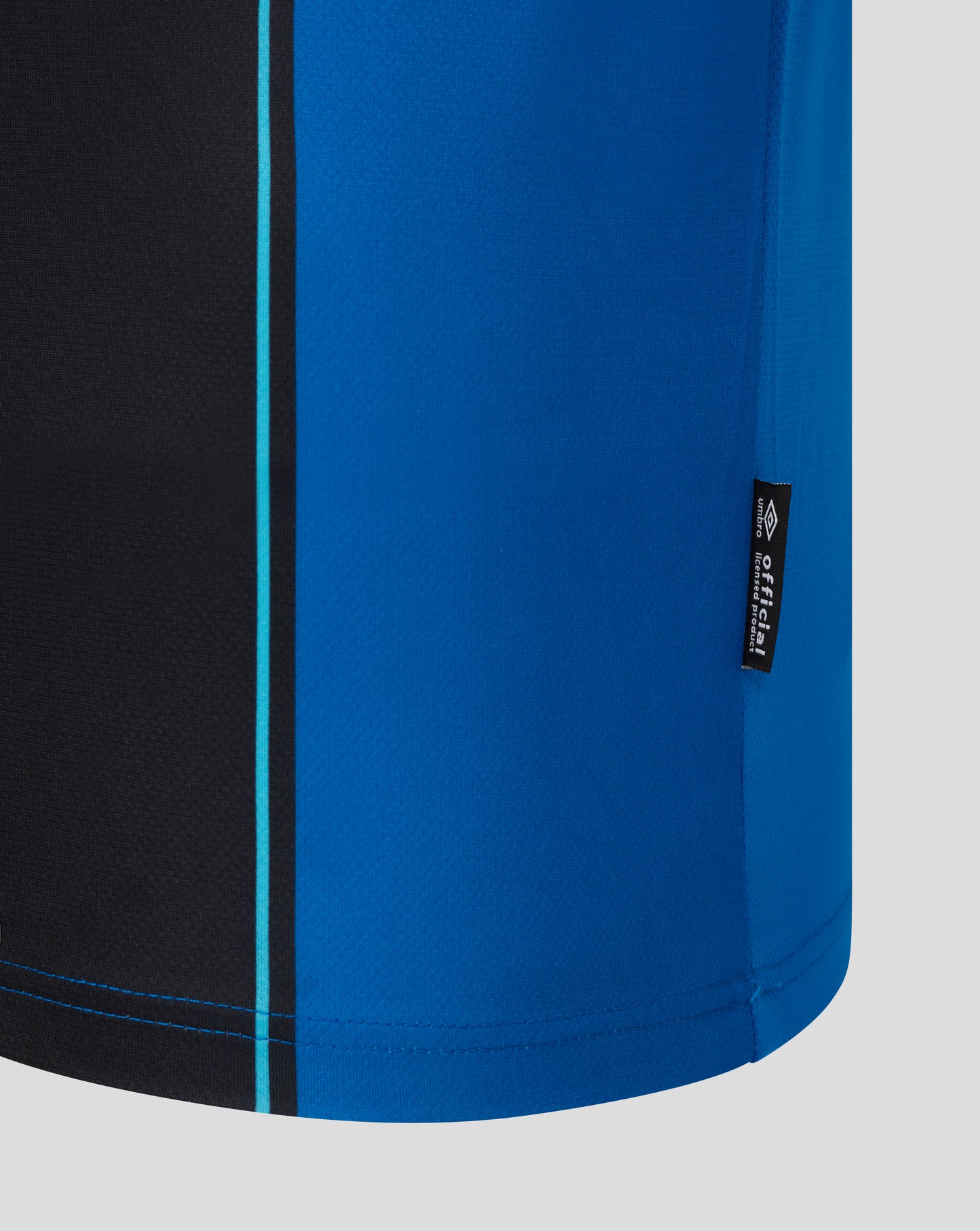 Close-up of AFC Bournemouth home shirt fabric in blue with black panel and turquoise piping.