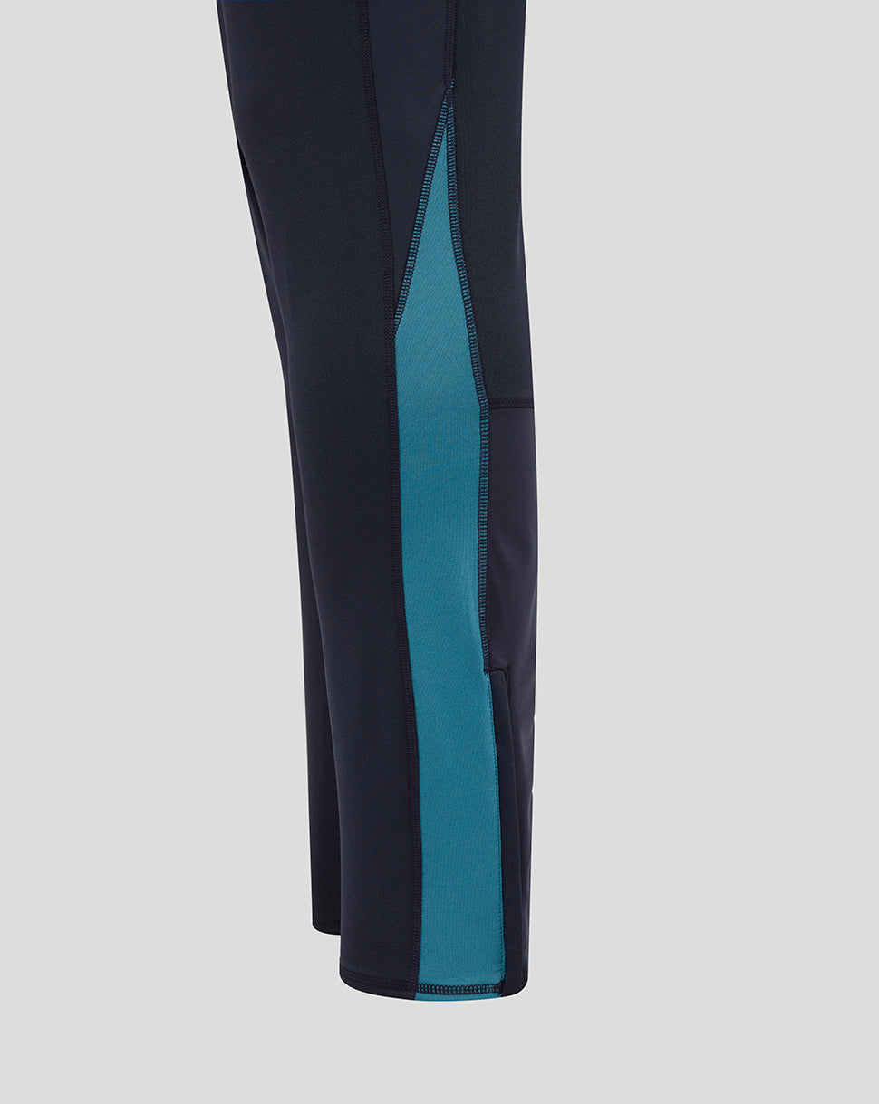 Side view of navy drill pants showing a teal side panel along the leg and contrast stitching