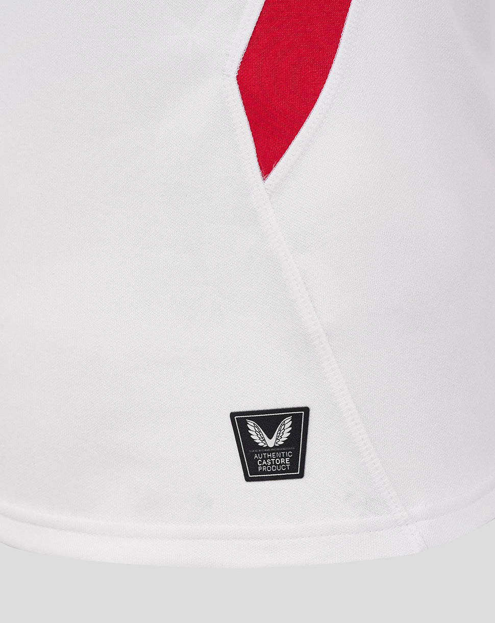 White England Rugby Home Pro short sleeve shirt close up showing a red angled side panel and a Castore authentic product badge at the hem