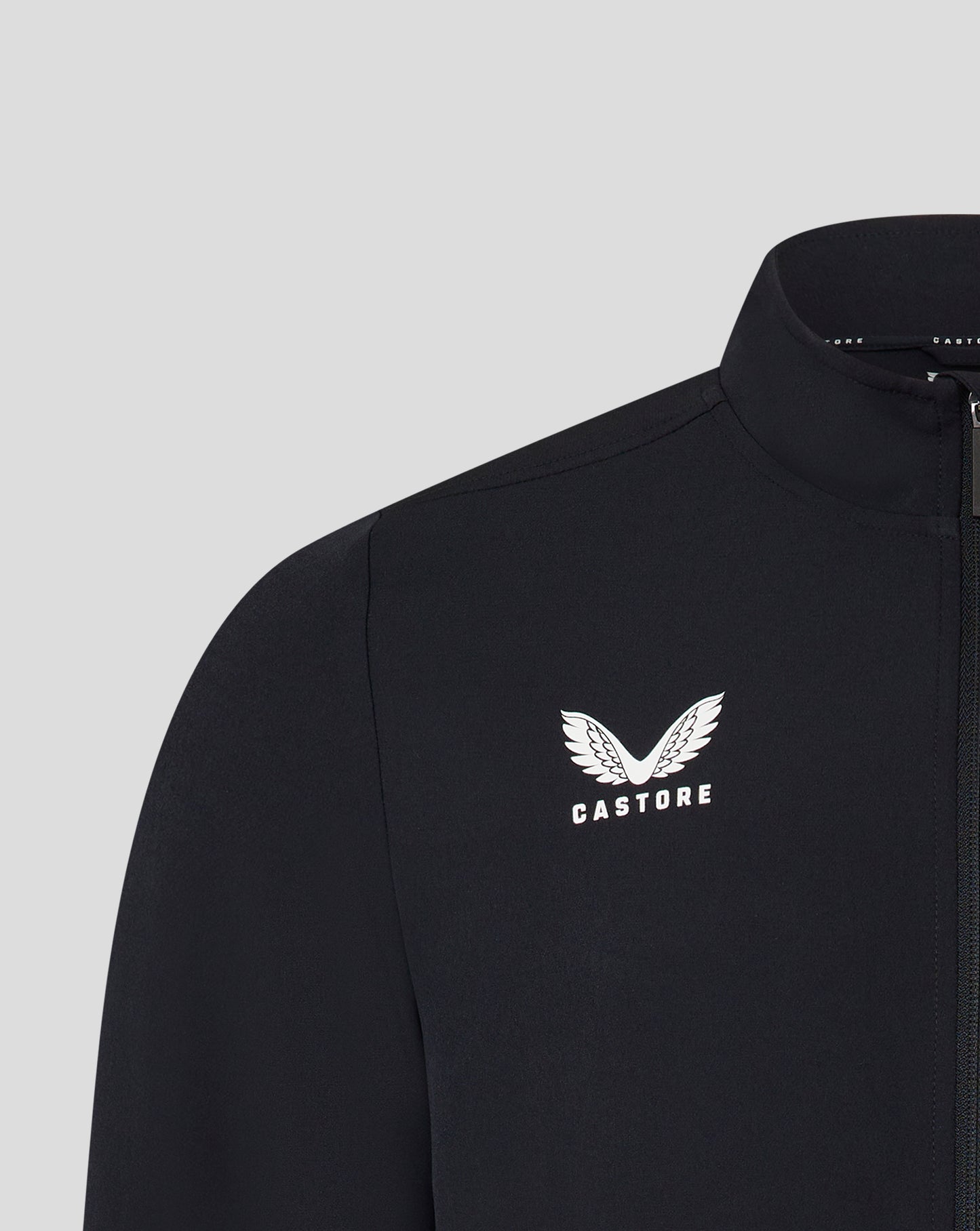 Close-up of the left chest showing the white Castore wing logo on a black track jacket