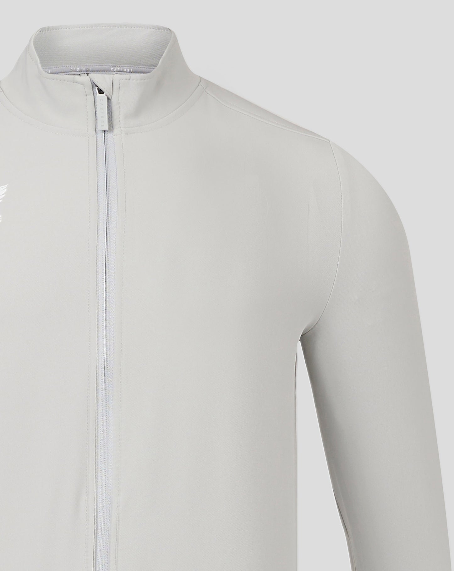 Close-up of collar and front zip on light gray Mens Track Jacket High Rise with Castore branding.