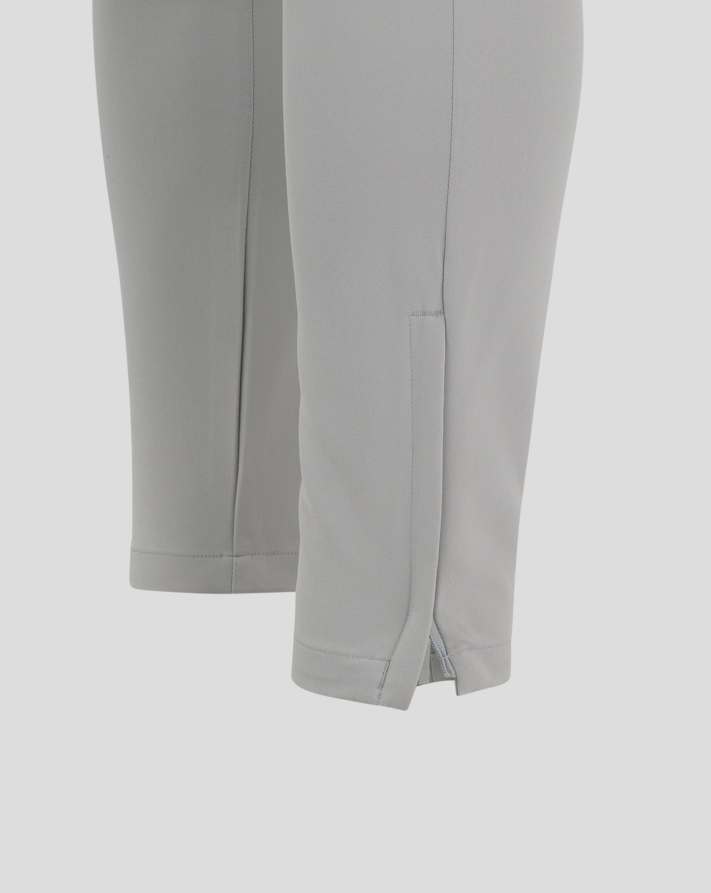 Thigh area of light gray track pants with Castore logo on the leg