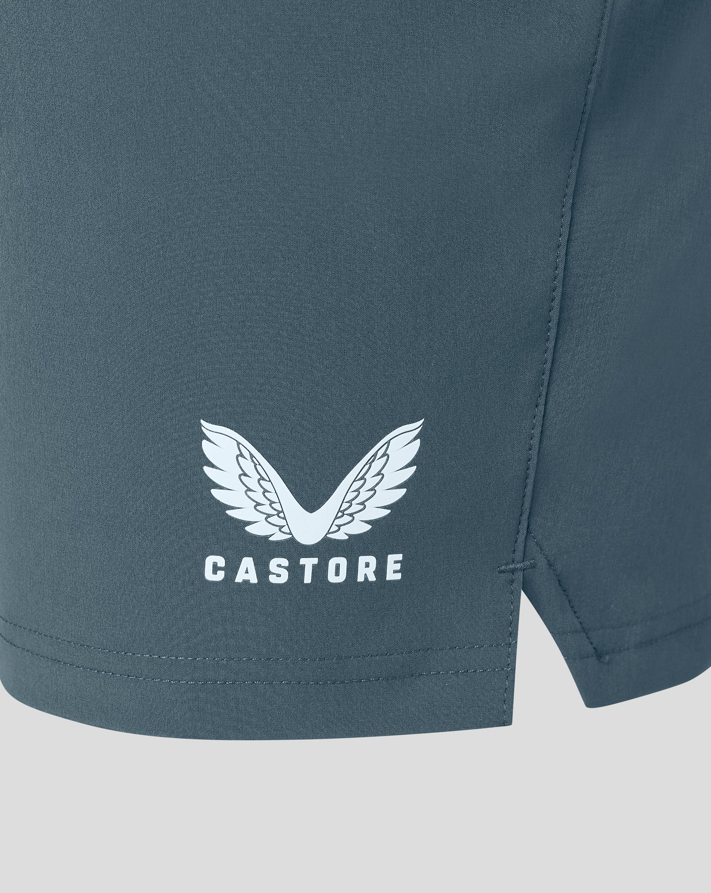 Rear view of dark slate woven training shorts showing center seam and fabric texture