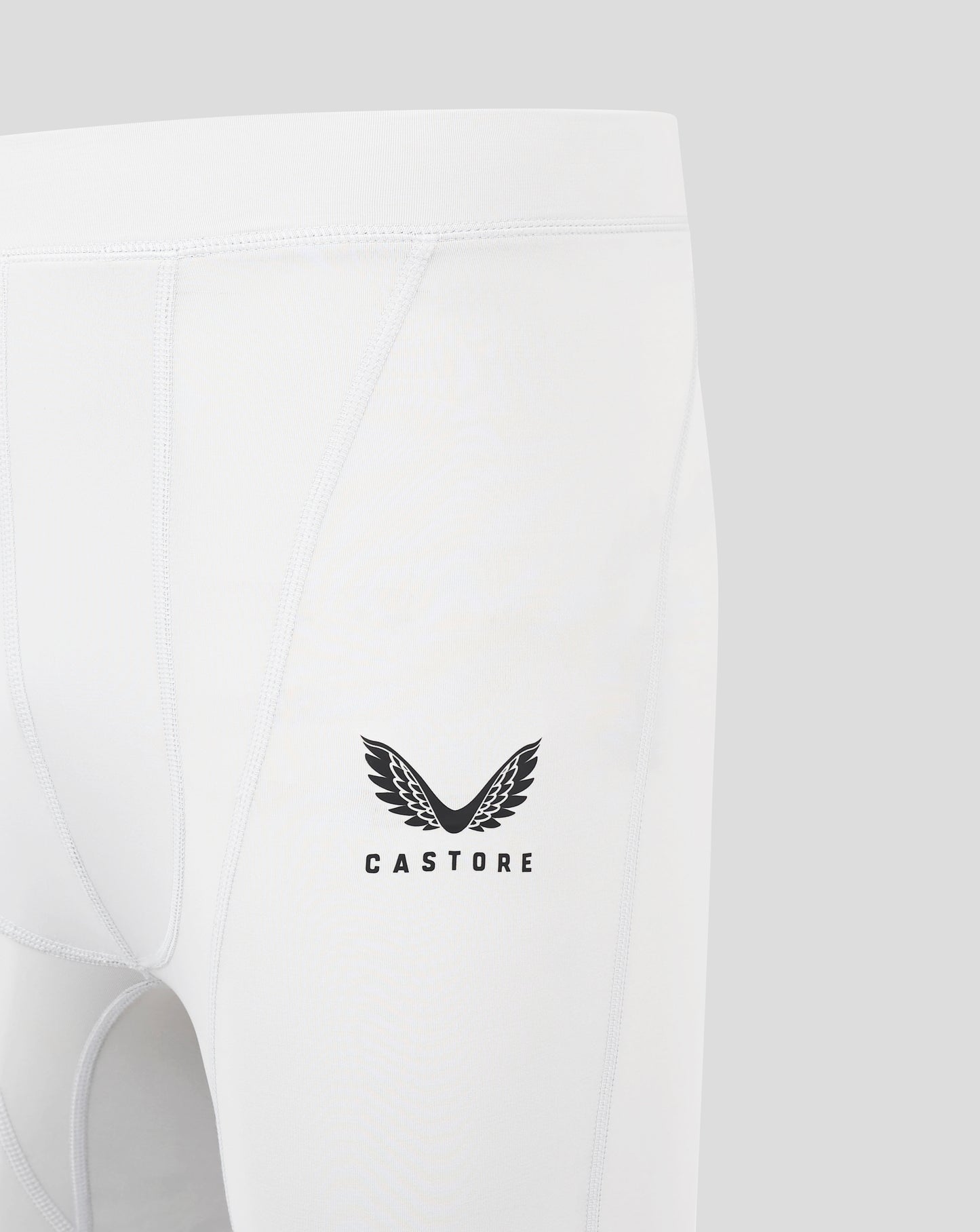 Back close up of white baselayer shorts with seam panels and a Castore logo near the lower center