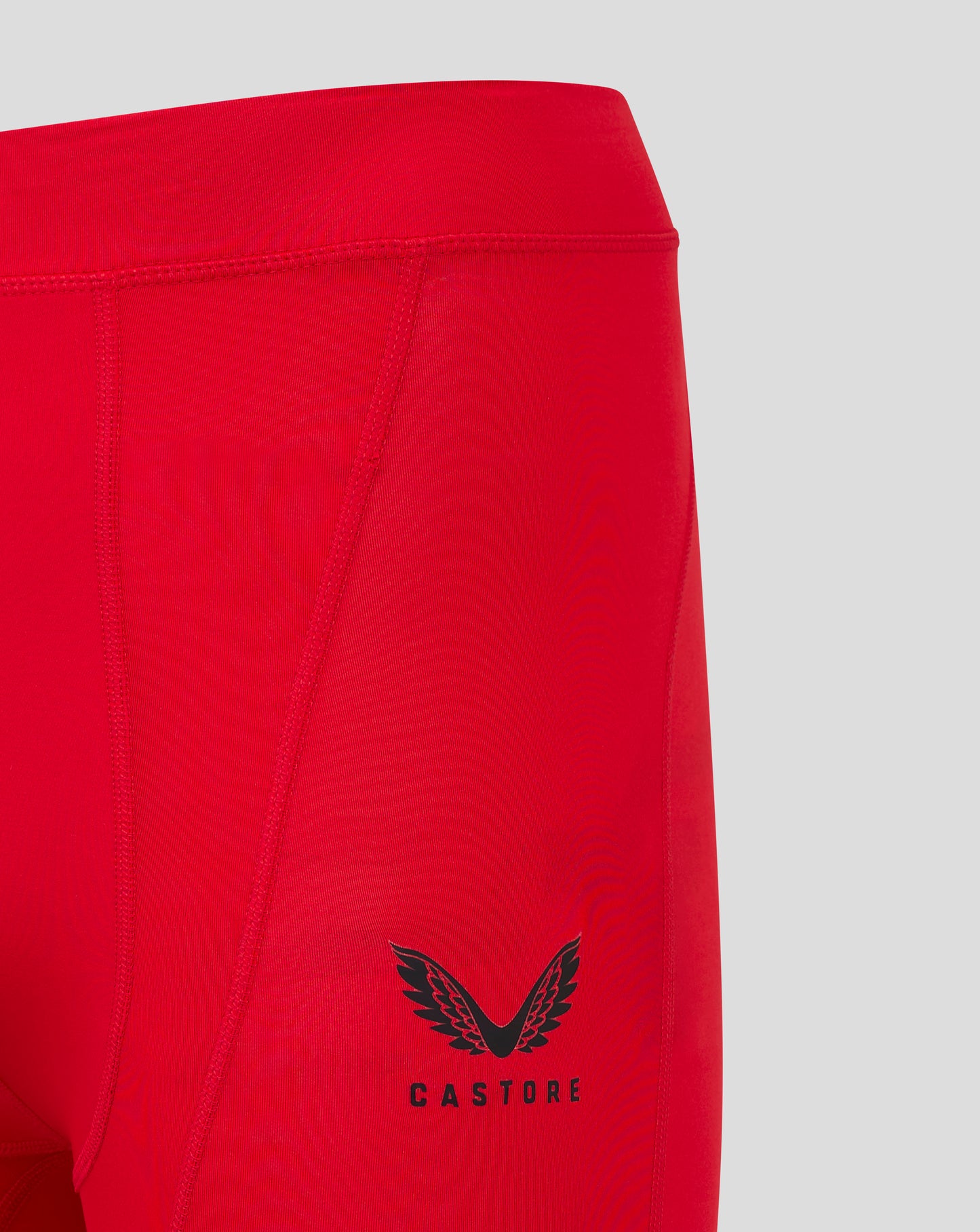Close up of red baselayer short waistband with flatlock stitching and panel seams