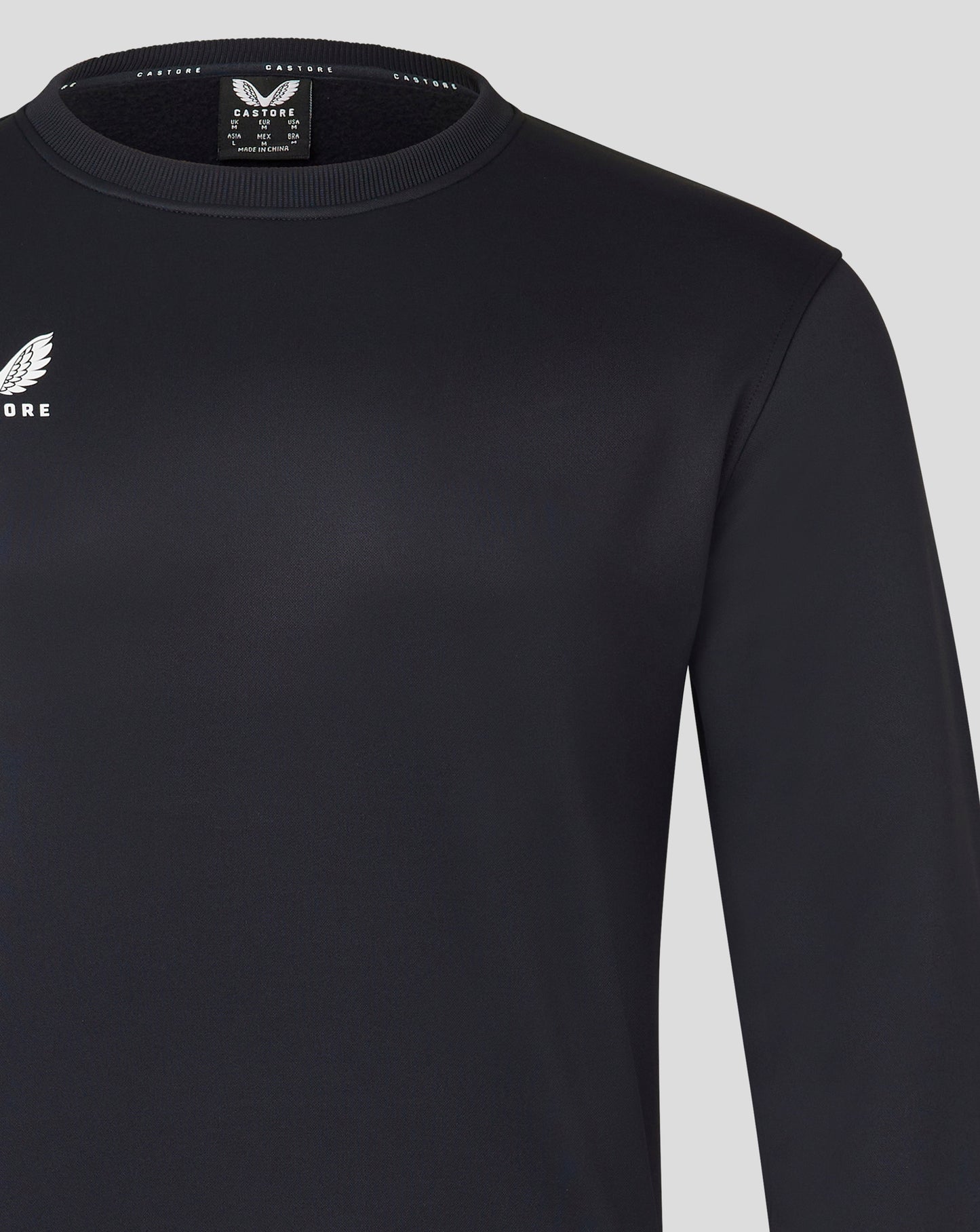 Close up of Mens Brushback Sweatshirt in Caviar showing ribbed crew neck and Castore logo on chest