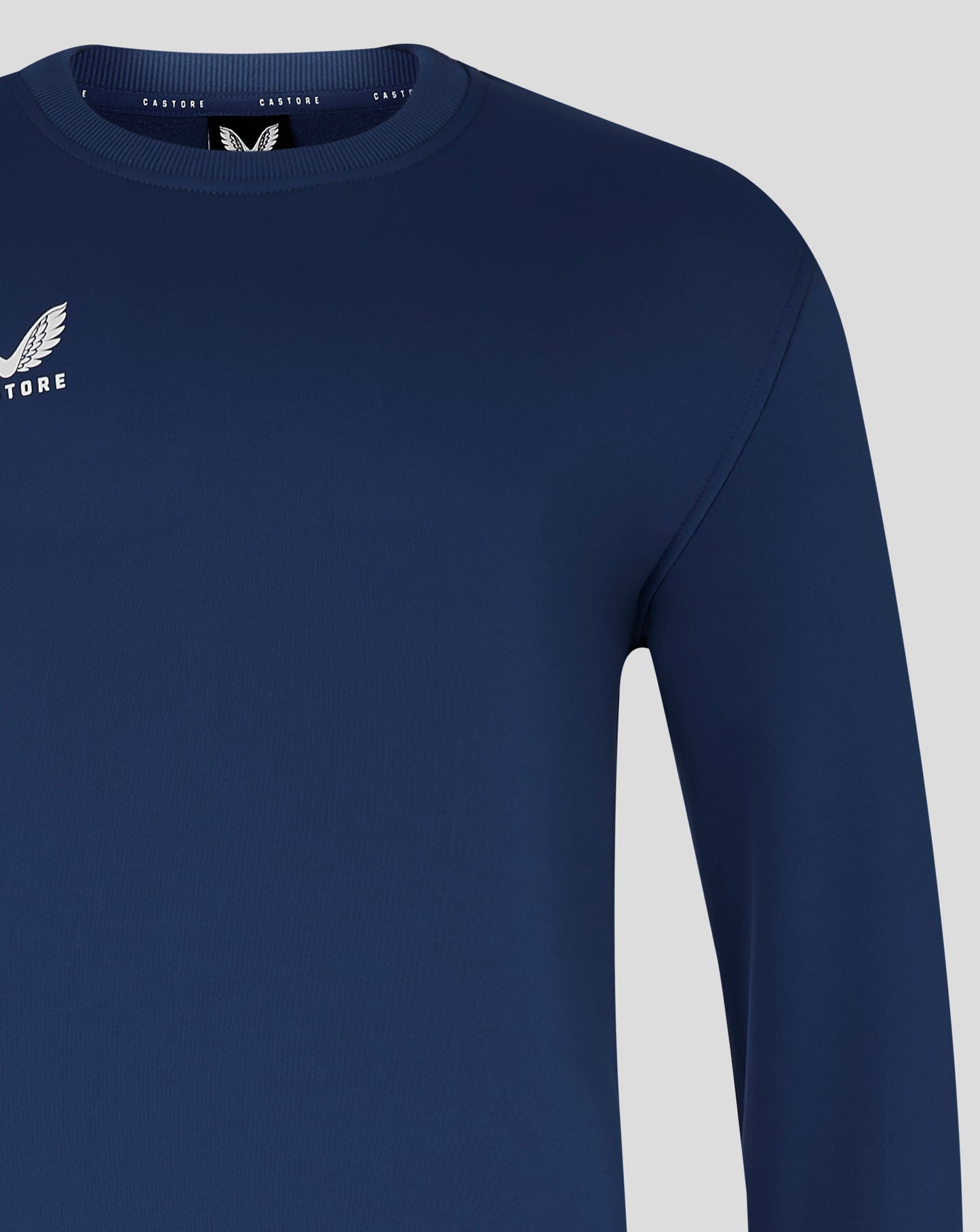 Mens Brushback Sweatshirt in navy with white Castore wing logo on the left chest.