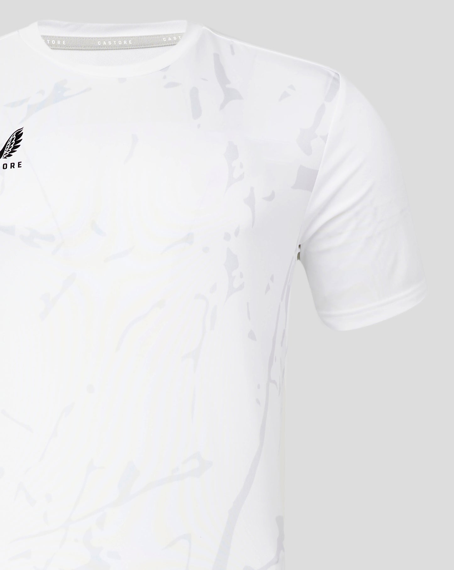 Brilliant white marble printed training tee with subtle gray pattern and wing logo on the left chest