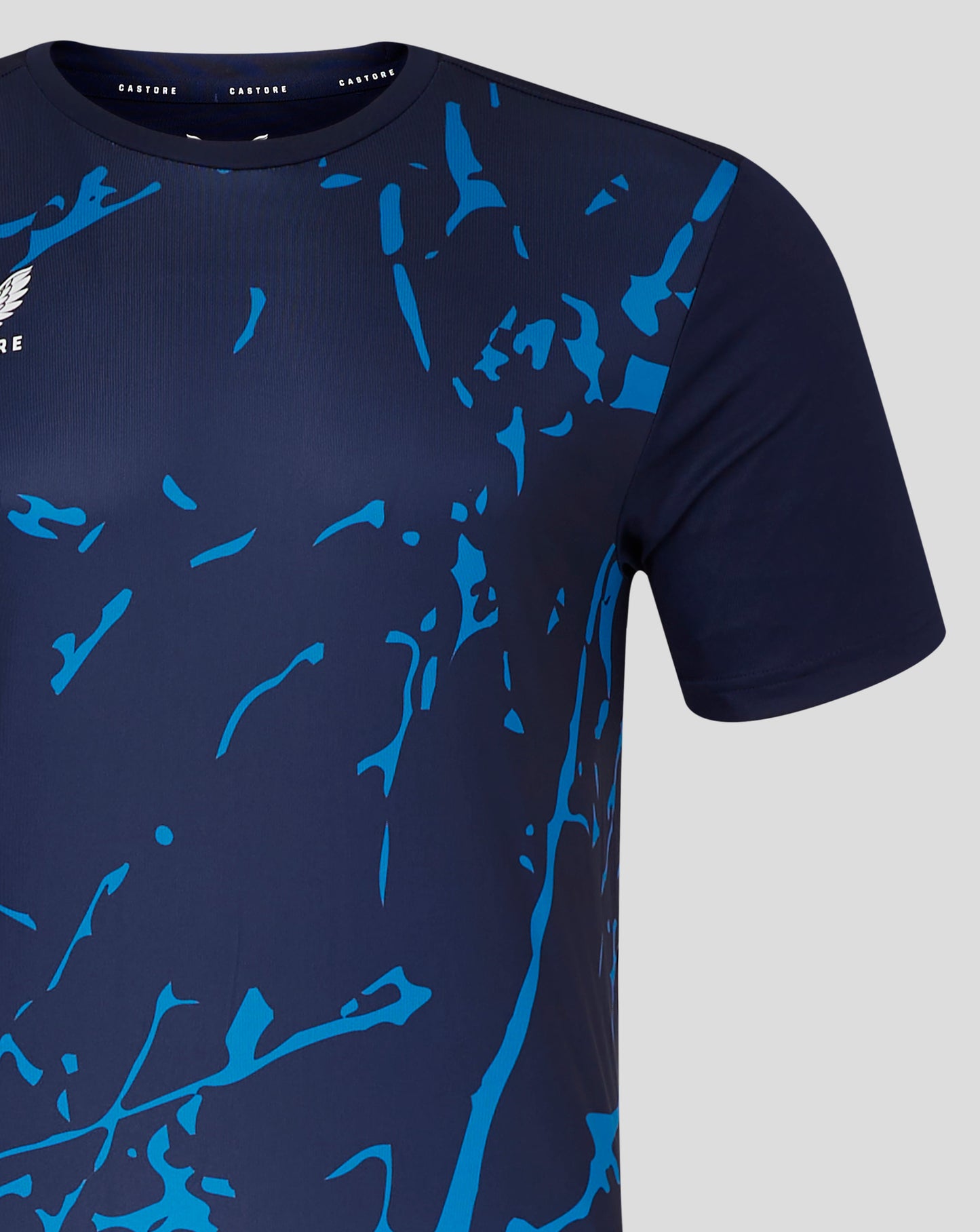 Front view of navy Marble Performance Tee in Peacoat with blue abstract print and Castore logo on chest