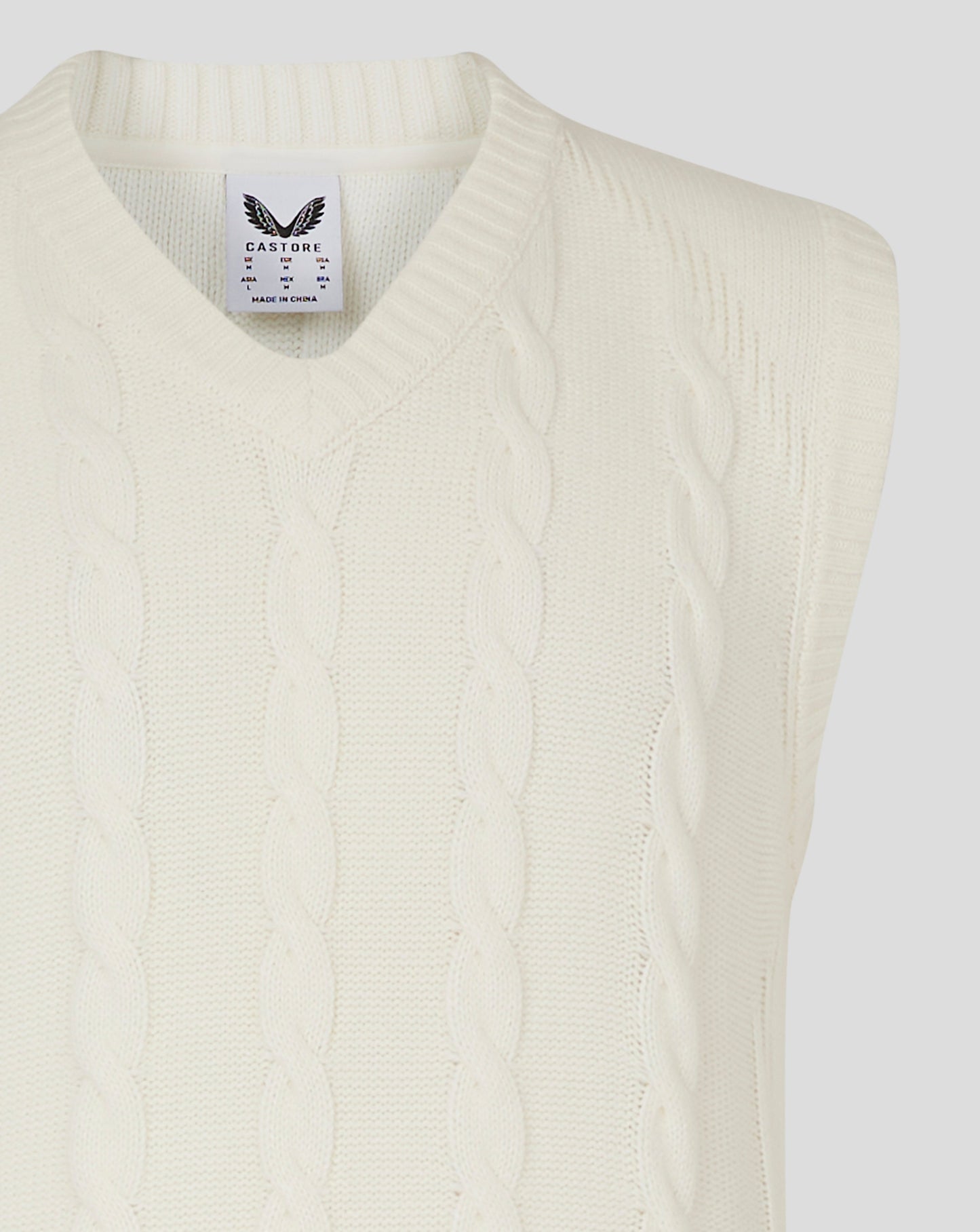 Cannoli cream sleeveless knitted jumper with cable pattern and V neck Castore label at the neckline