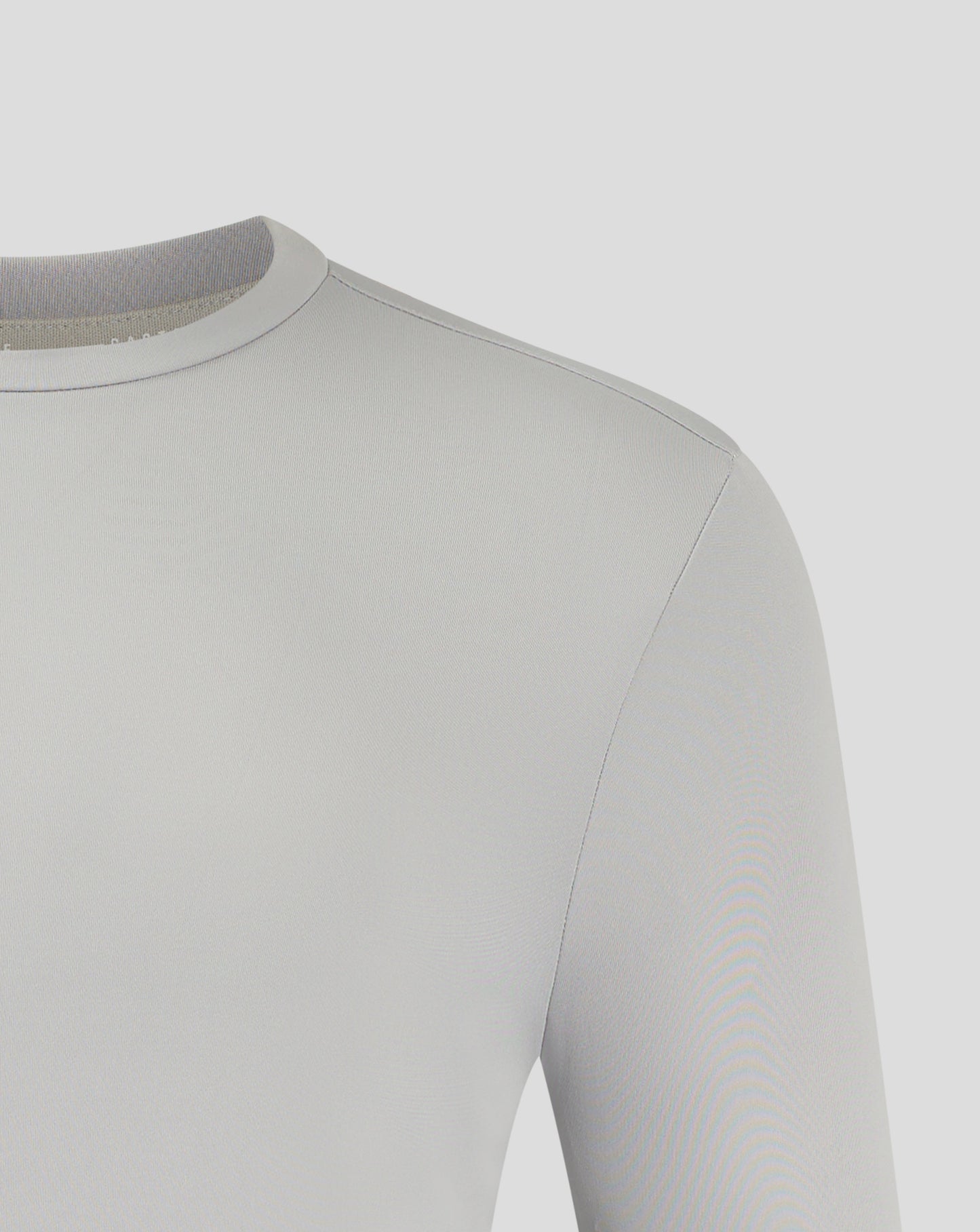 Upper shoulder and neckline detail on white performance tee