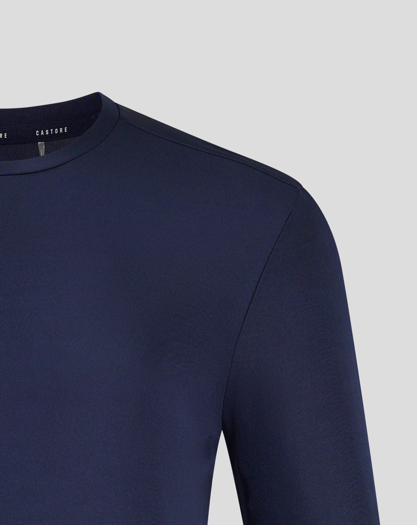 Front view of navy Peacoat long sleeve tee displaying Castore crest and logo centered on the chest