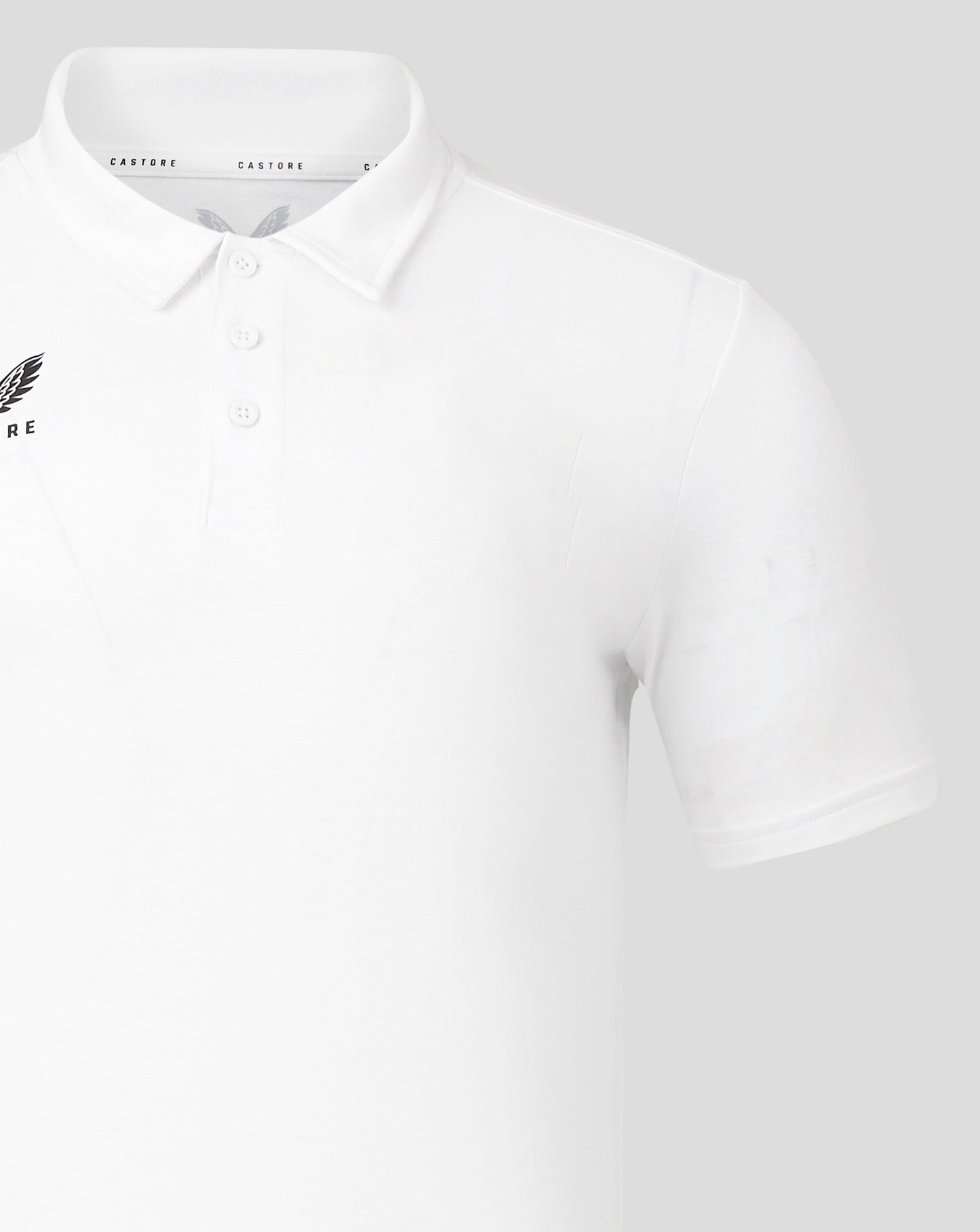 White polo with Castore crest on left chest and button placket.