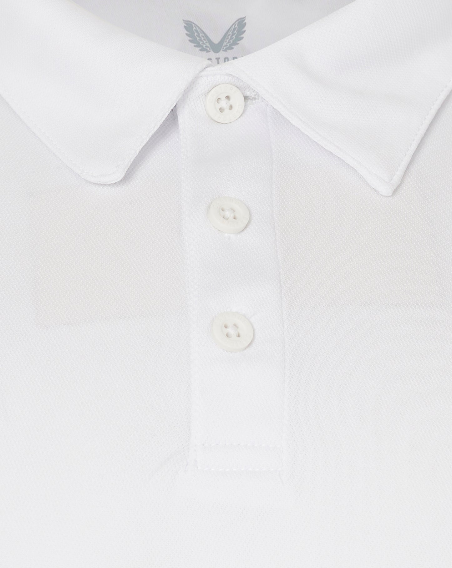Close-up of a white shirt collar with a button placket and textured fabric.