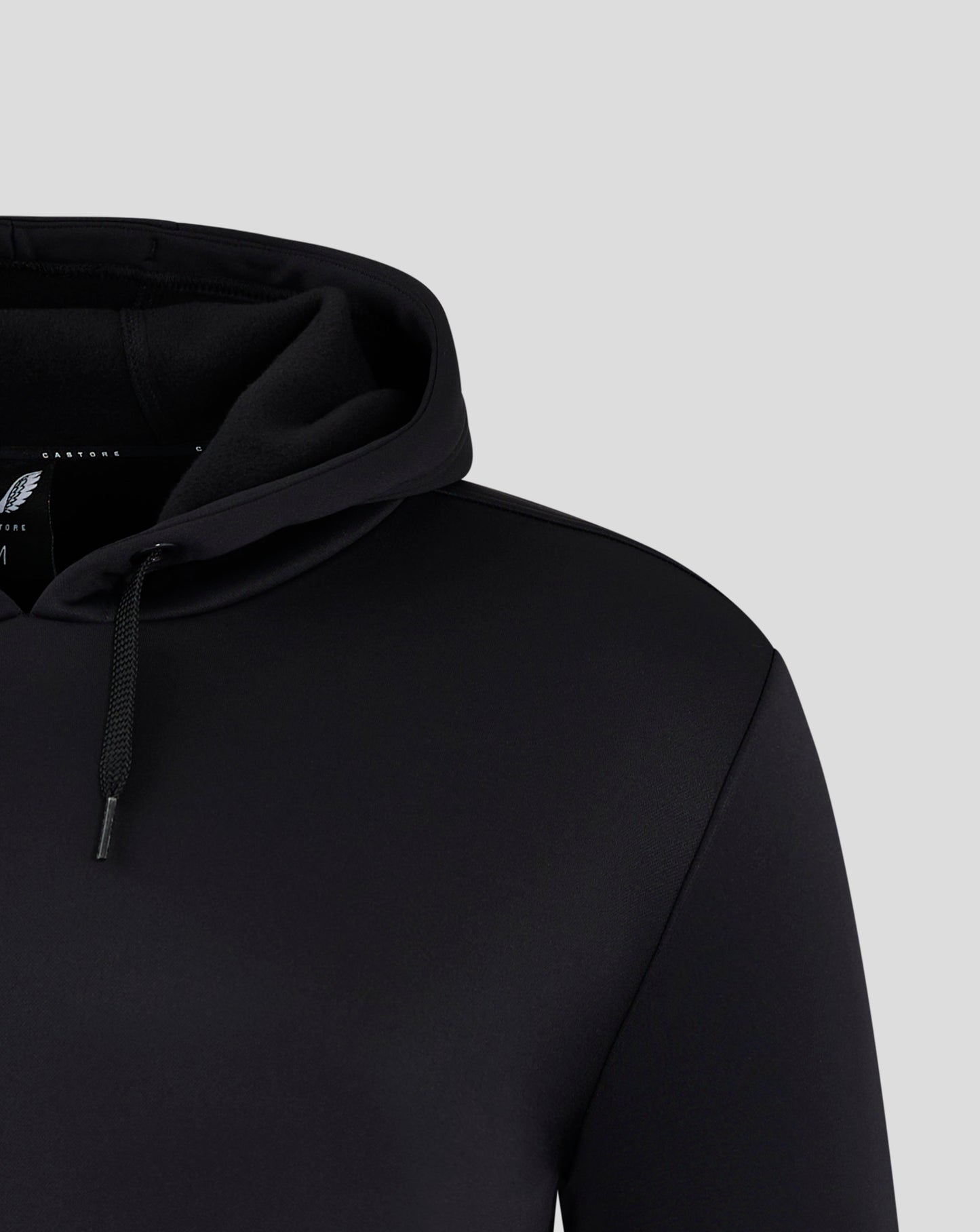 Partial view of black hooded sweatshirt showing the hood and drawstring.