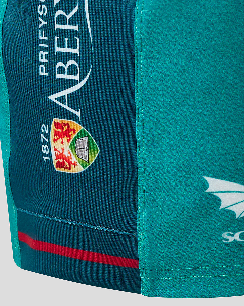 Close up of teal Scarlets away shorts side panel showing crest and 1872 patch with sponsor graphics