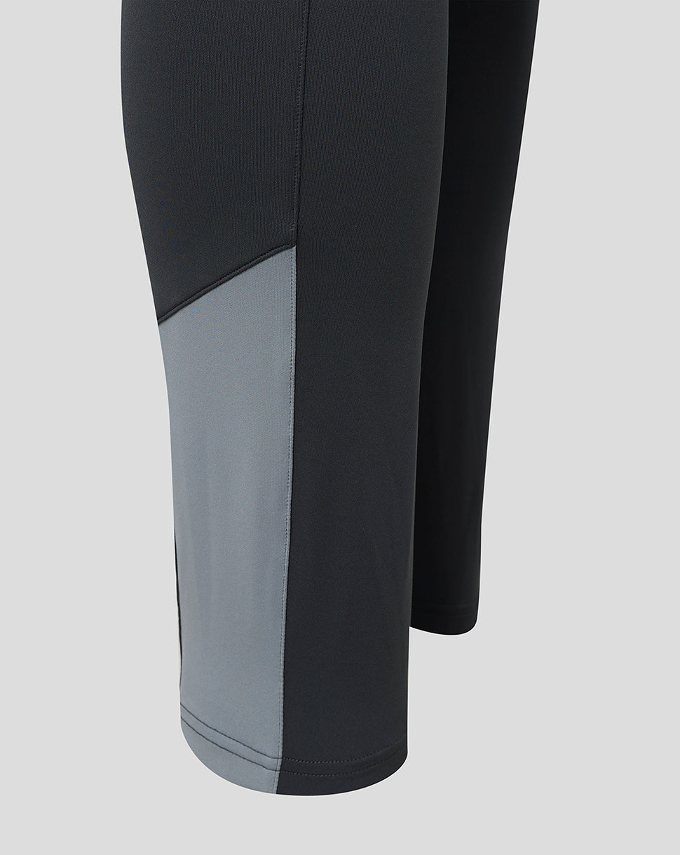 Scarlets training pants leg close up with dark fabric and a light grey color block panel.