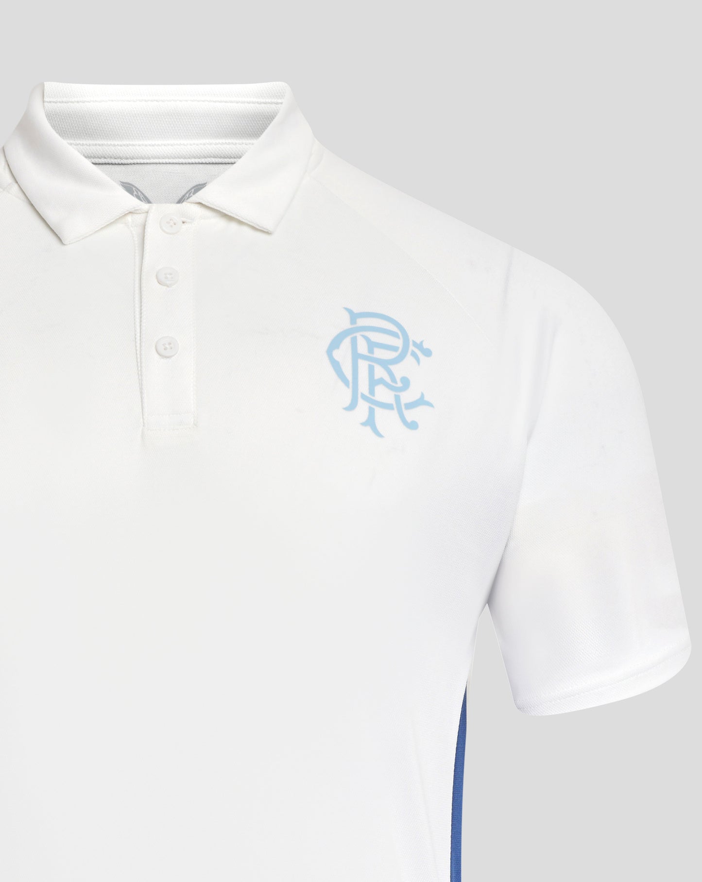 Close-up of white Rangers polo shirt showing collar buttons and a light blue crest on the left chest