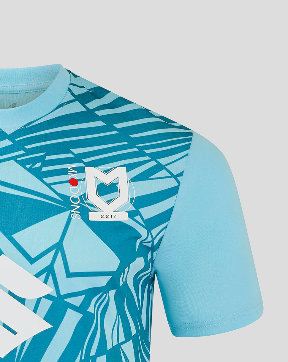 Chest area of Mk Dons 24/25 third goalkeeper shirt with crest and bold blue geometric pattern.