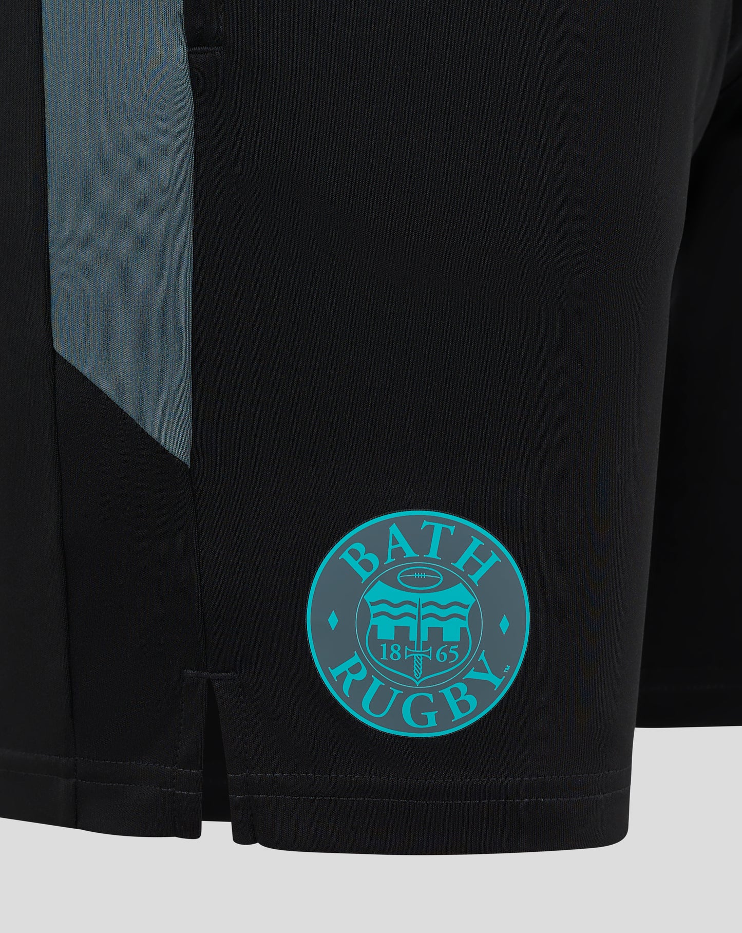 Close-up of Bath Rugby shorts with teal club crest patch on the leg and Castore branding visible