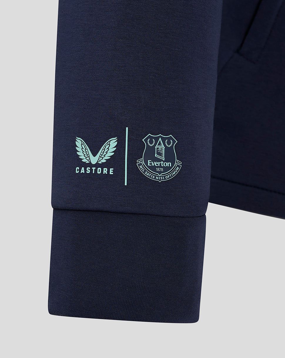 Cuff area of navy sleeve with Castore logo and Everton crest side by side