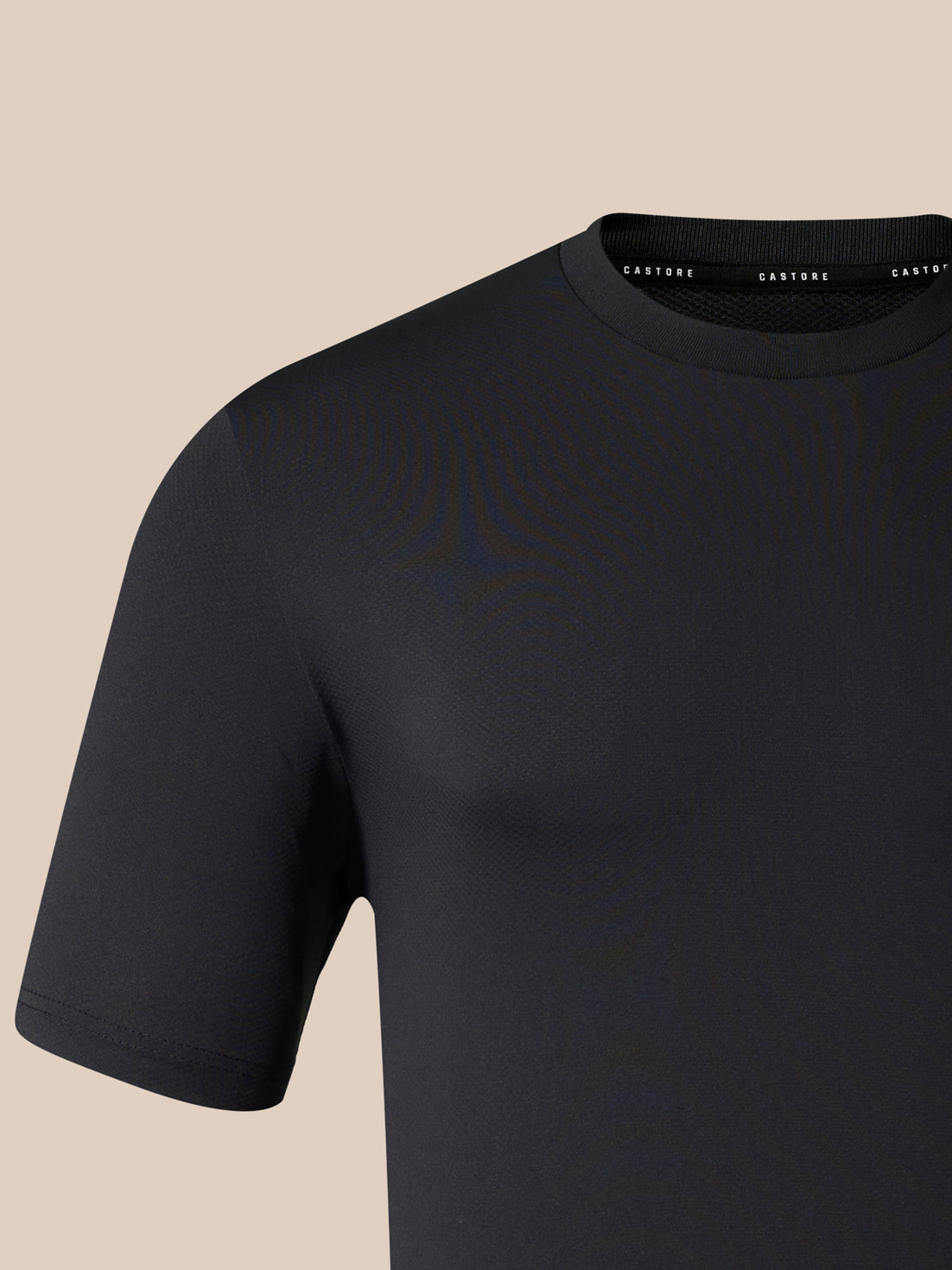 Black short sleeve tee shown in close up with white Castore wing logo on the left chest.