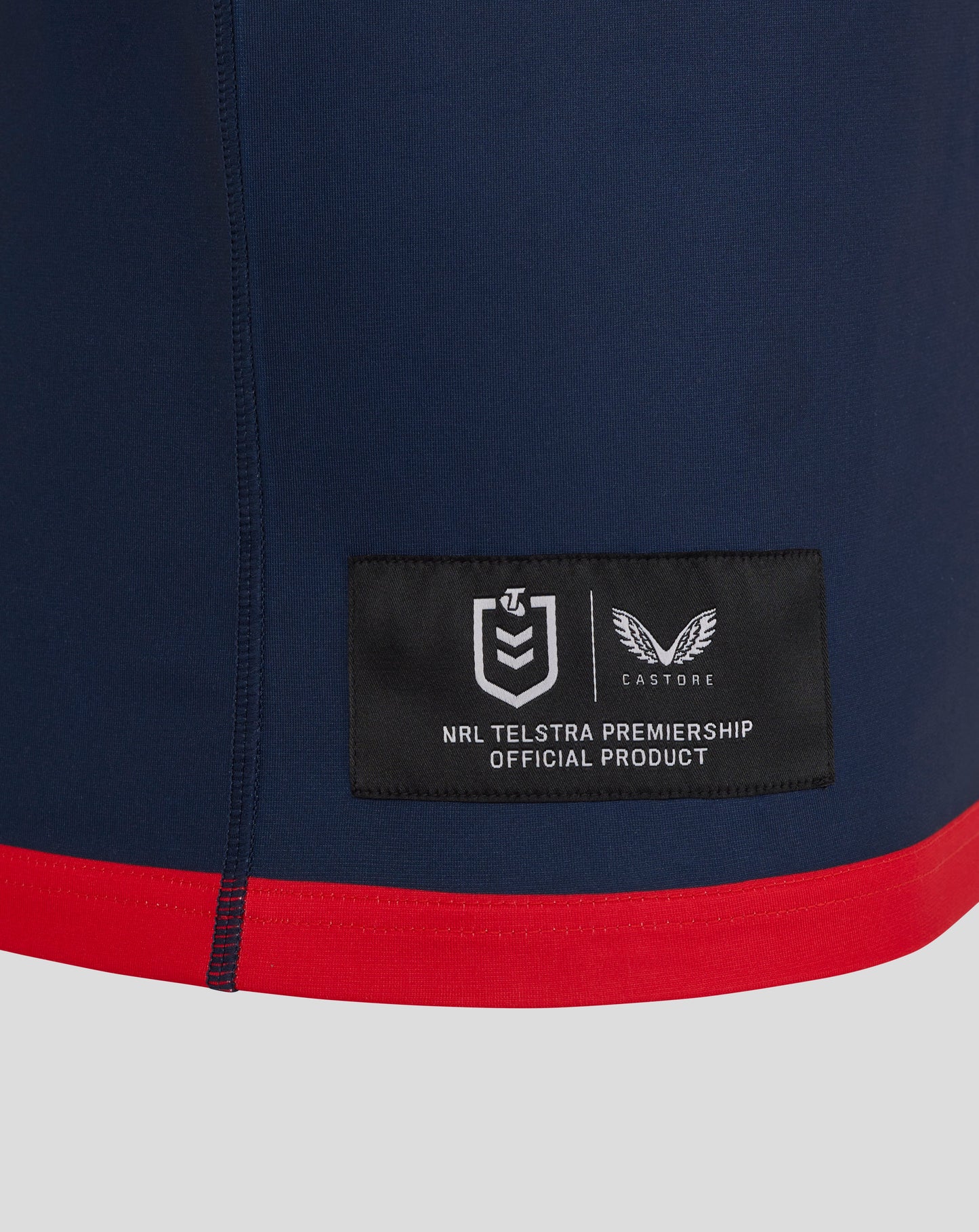 Sydney Roosters 2025 men's home jersey navy fabric close up with red hem and official patch