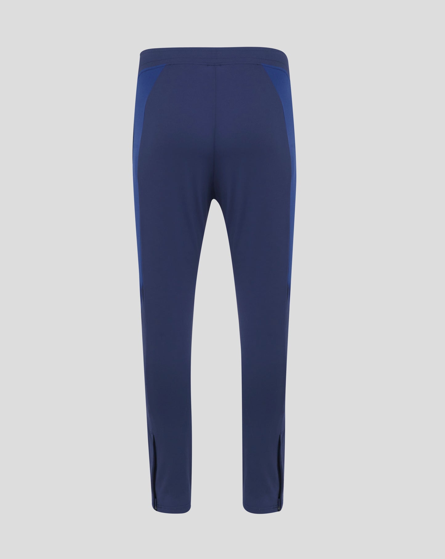 Back view of navy and blue colorblock training pants with curved panels and a stitched waistband