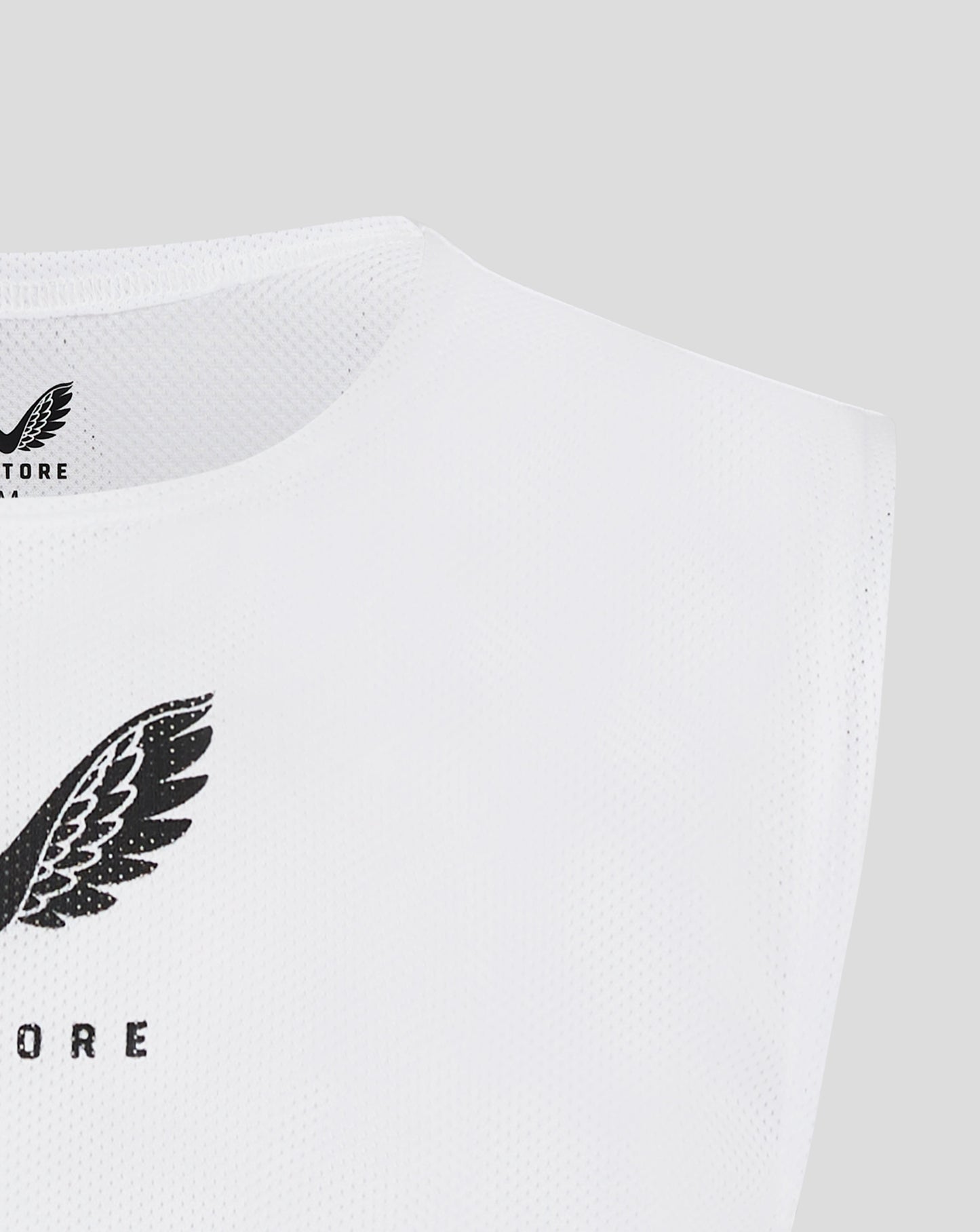 Close up of white mesh bib with Castore logo and wing motif along the side