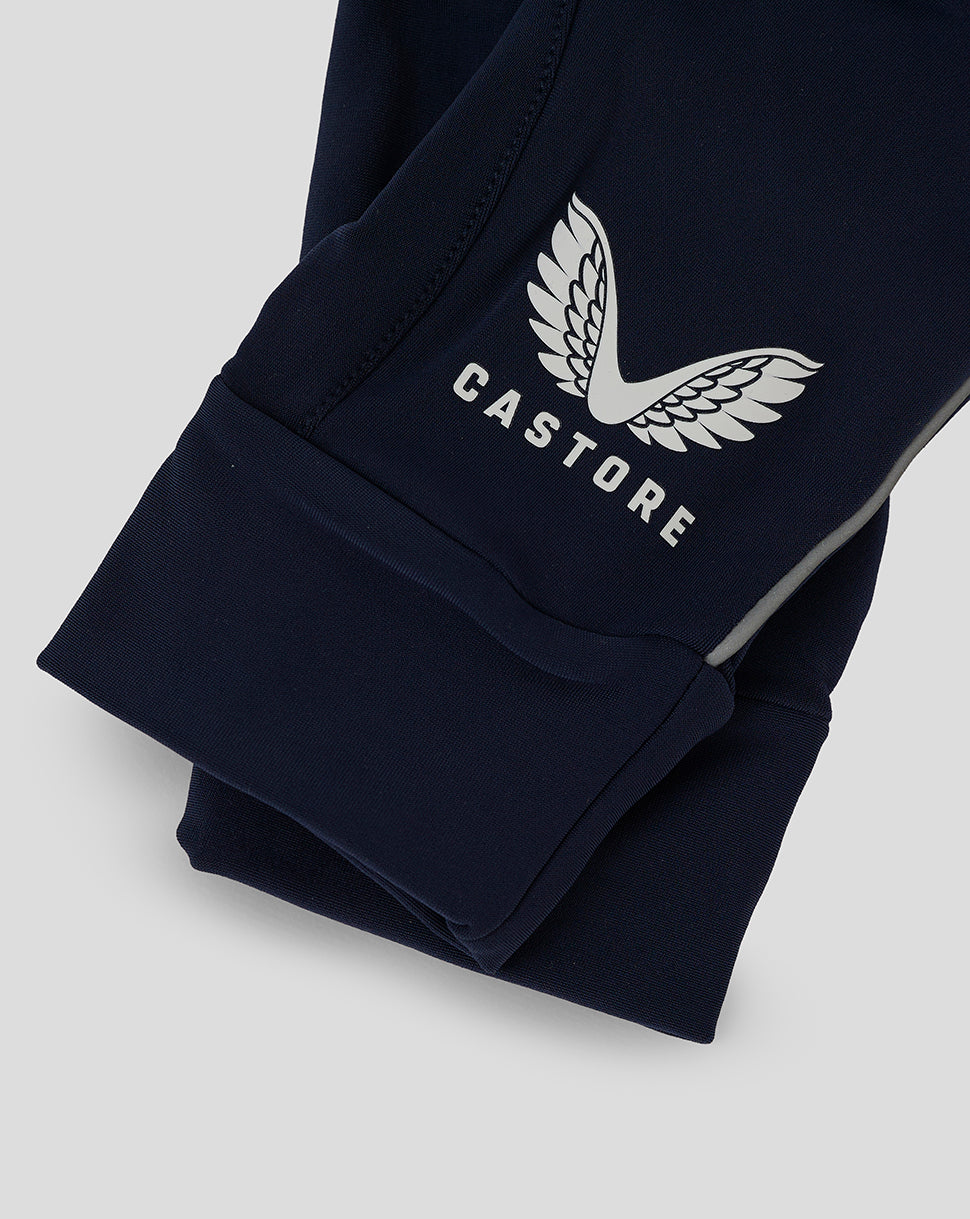 Close up of navy Castore glove cuff displaying white wing logo