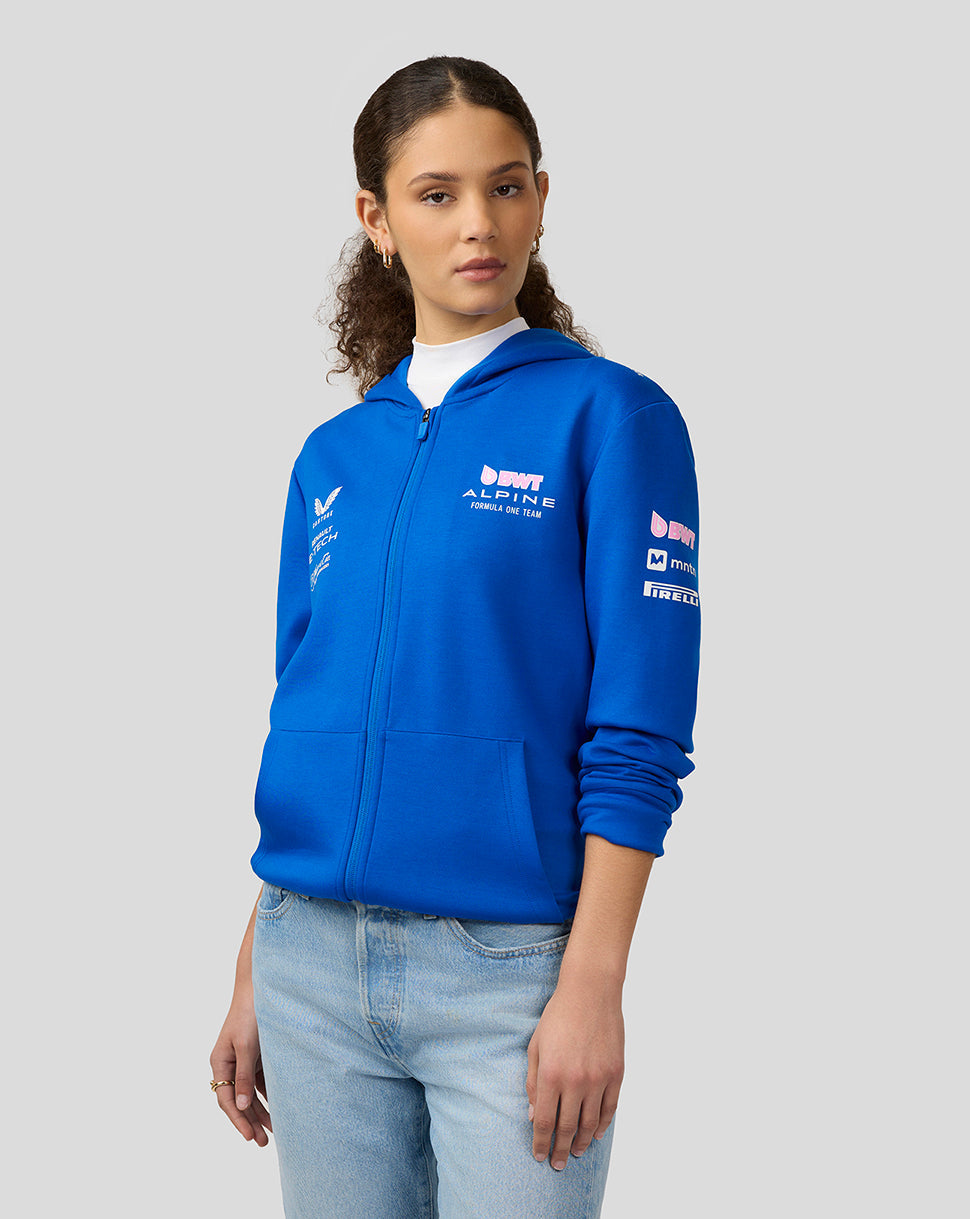 Woman wearing lapis blue BWT Alpine Formula One Team replica full zip hoodie with logos on chest and sleeve