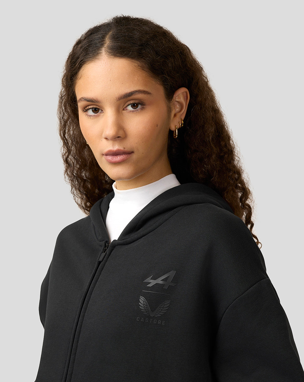 Model wearing black on black Alpine Formula One team zipped hoodie with oversized fit and chest logo.